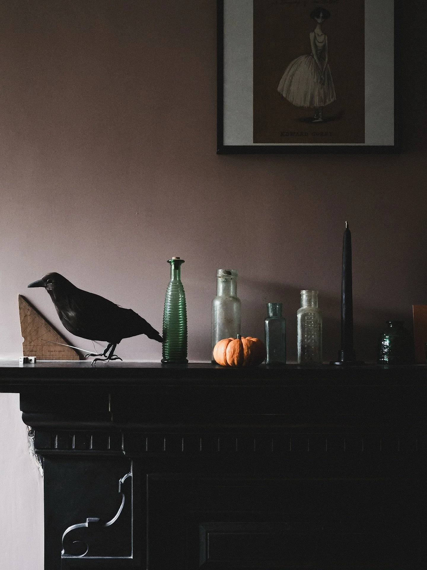 I was decluttering my bedroom yesterday, just the beginning of a rather overwhelming project. As a reward I have tweaked my dining room’s mantelpiece display for spooky season. My faux crow and Gorey illustration are year-round features, but th