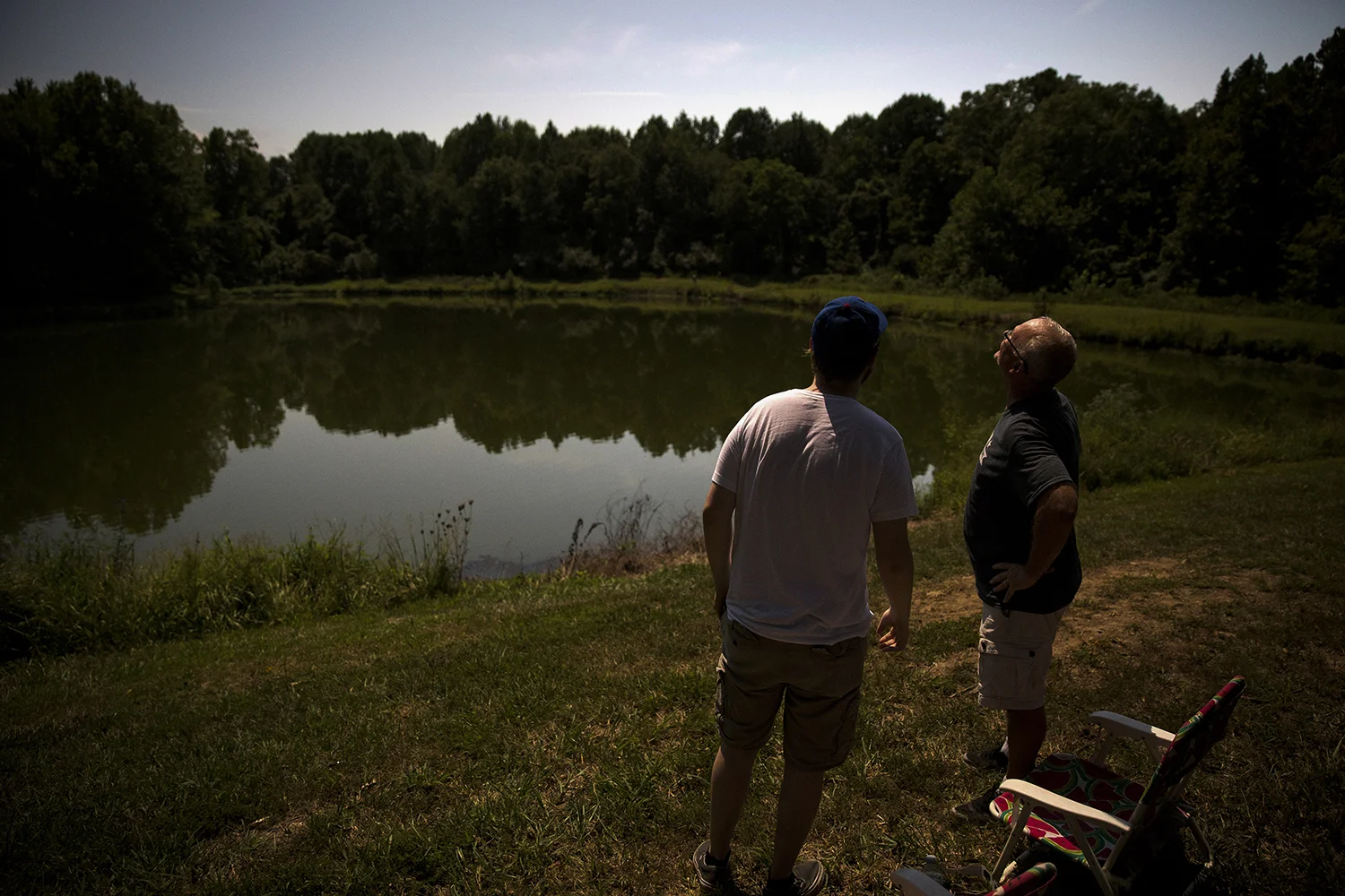 Jimmy Kowalczyk, left, and his dad, Dan, watch the eclipse during totality at Giant City State Park near Carbondale.