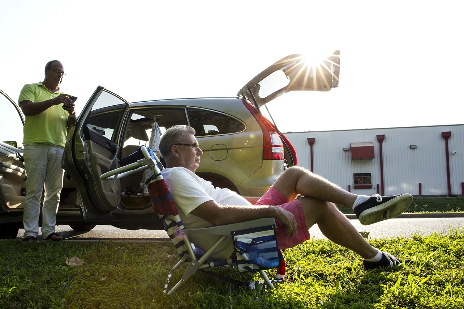 Rick Kasprzak, left, and Jim Lawless, drove overnight from Chicago and arrived in Carbondale before dawn to watch the solar eclipse. They joined others who parked behind a Huck's Convenient Store. 