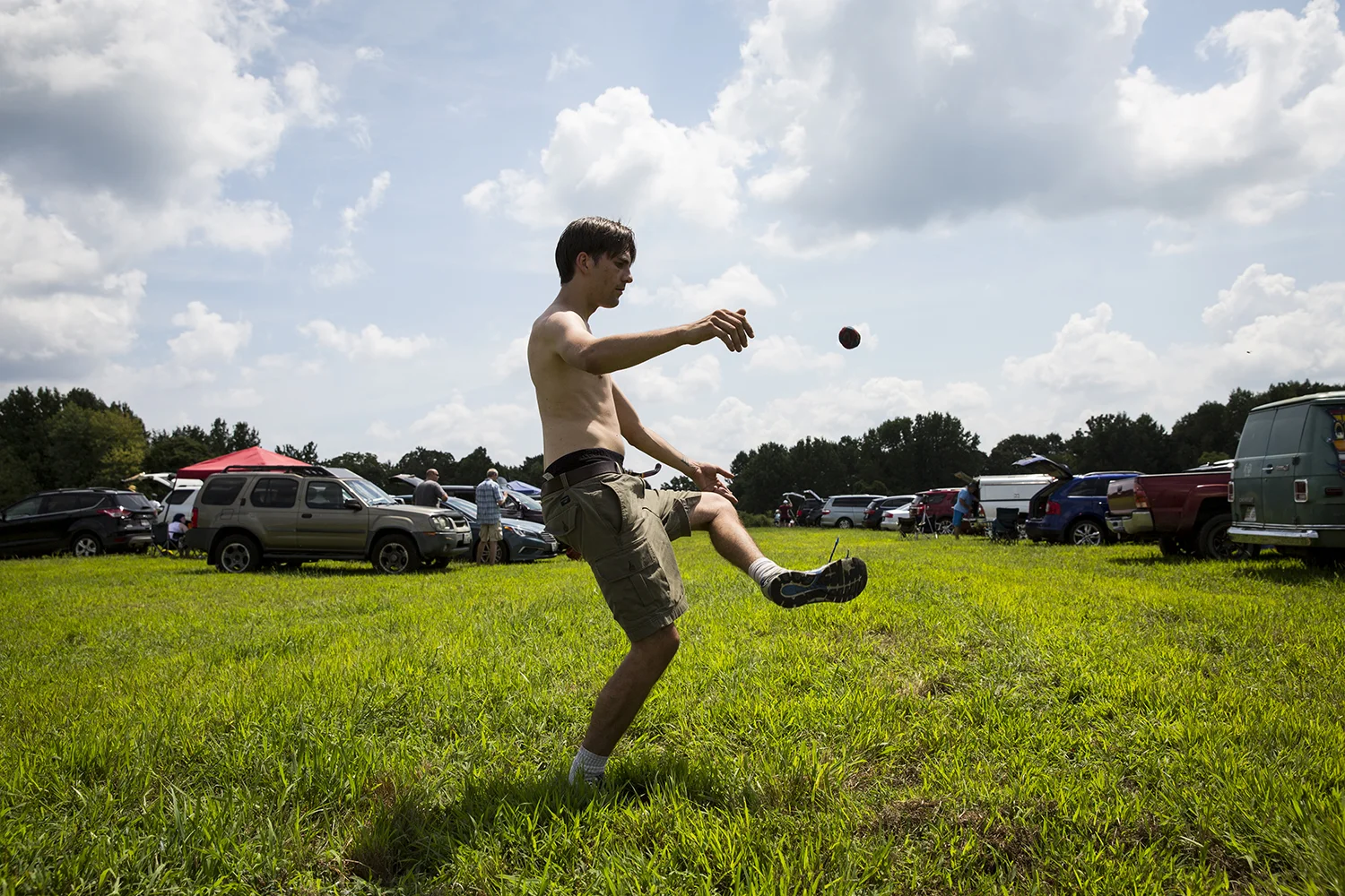 Charles Bailey, III, from Chicago, kicks up a hacky sack while waiting for the solar eclipse to begin in Giant City State Park near Carbondale. 