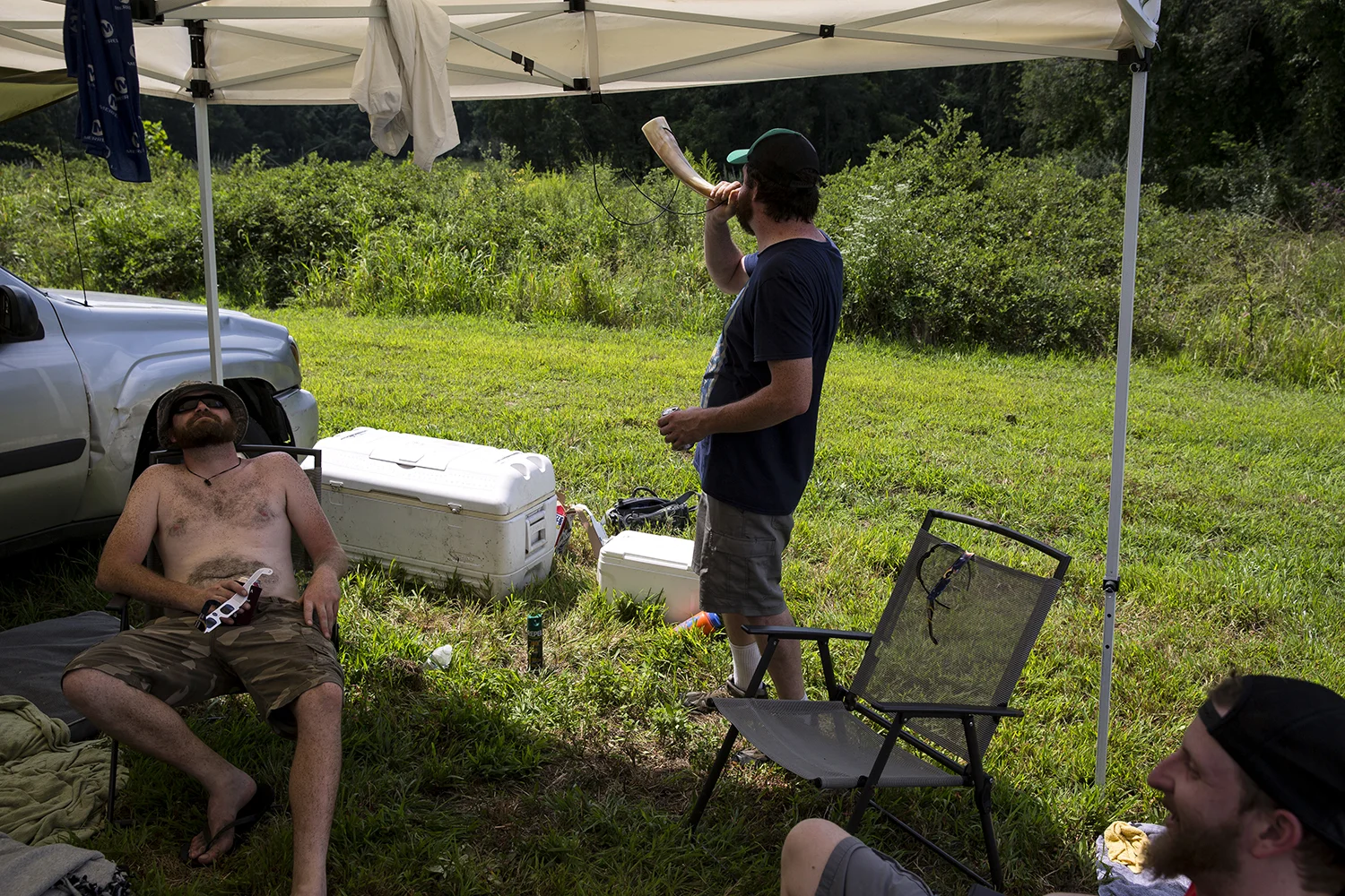 William O'Connor, left, his brother Sean, both from Chicago, and Justin Moll from St. Louis wait for the solar eclipse to begin at Giant City State Park near Carbondale.