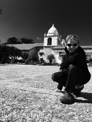 snapping a pic at the subject's level, adding depth + texture with the groundscape, capturing the mission in the background + minimal sky • 'noir' filter