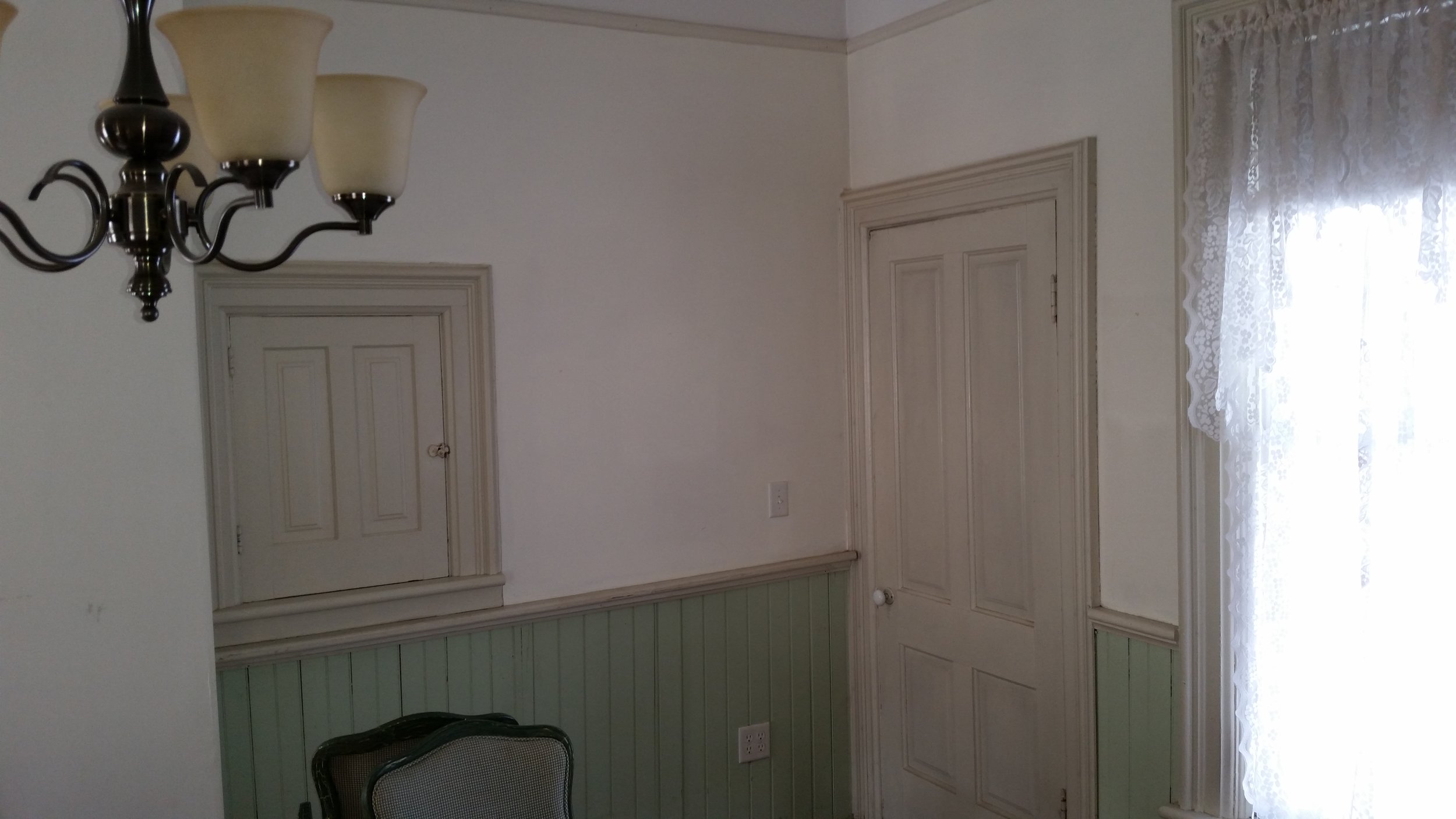 Notice the wainscot on the lower wall section. It was in poor repair in places and was too informal for the dining room we had imagined. The reach-thru to the kitchen was a source of much consternation. We really didn't want to remove it, but it interfered with placement of wall sconces and anticipated furnishings. Eventually we decided to close it off in the formal dining room, but kept it open on the kitchen side. 