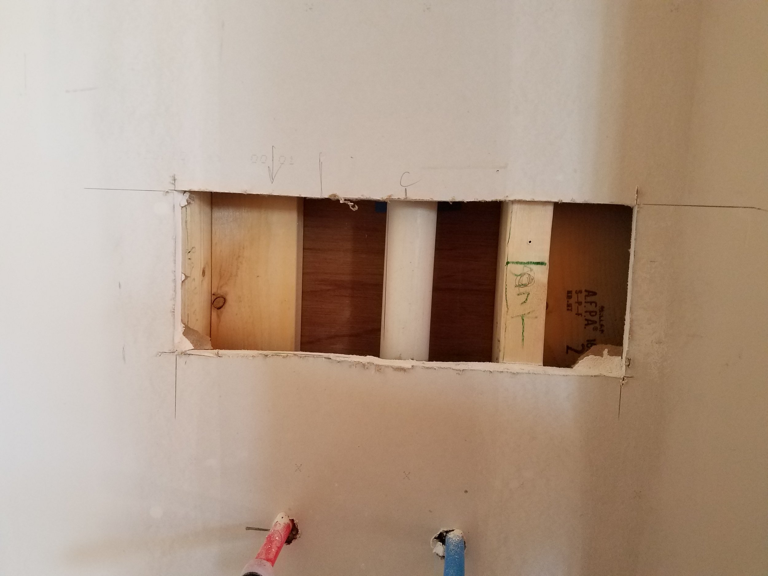 Of course we didn't plan ahead when we originally sheet-rocked the room so we had to open up the wall again to put in a solid backing for the pedistal sink. 