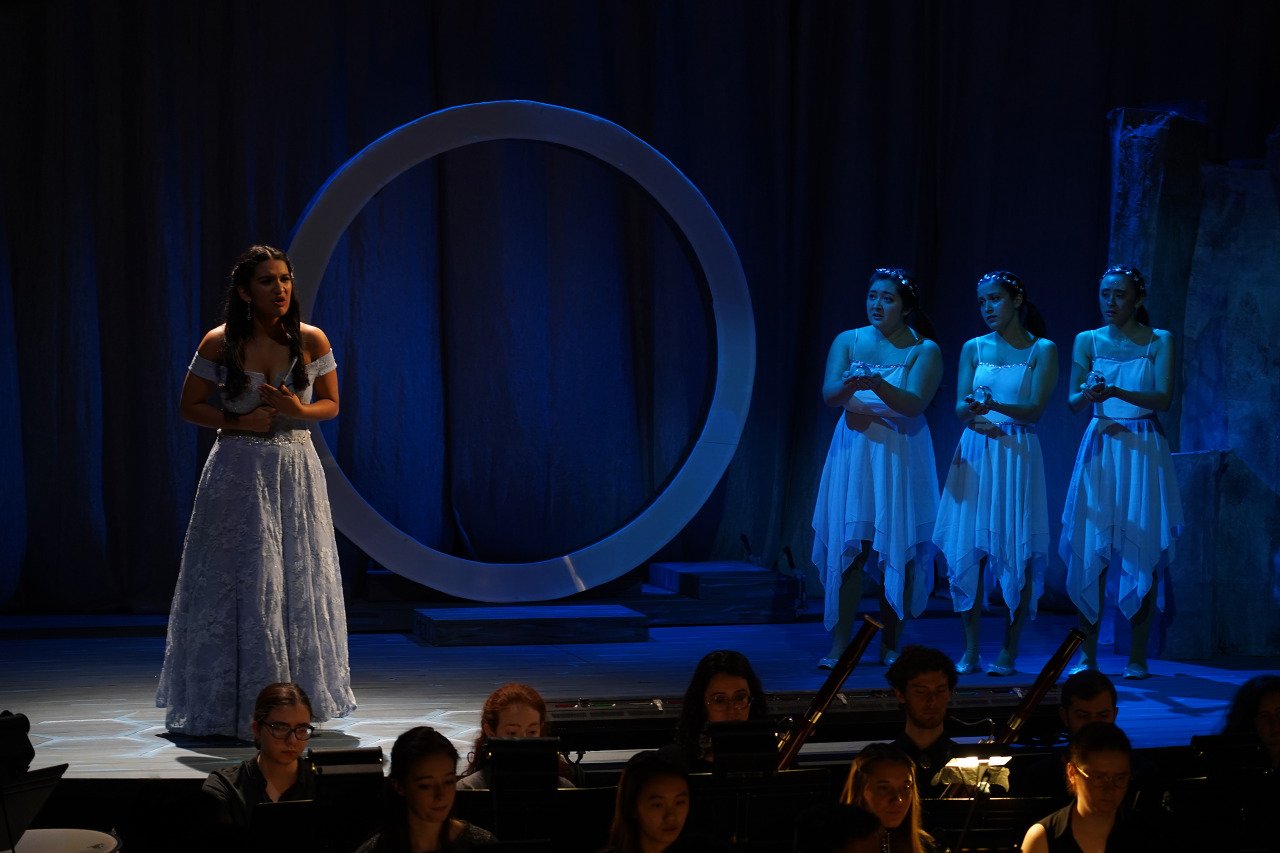  Act II: Three child-spirits (Sydney Penny ’22, Katharine Courtemanche ’21, and Olympia Hatzilambrou ’23) rush to the aid of a heartbroken Pamina (Jahanavi Rao ’22), who is contemplating taking her own life after her lover refuses to speak to her wit