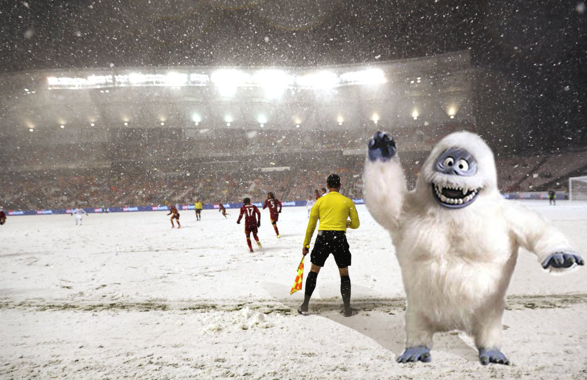 Assistant Referee Ian Anderson works in the shadow of a Yeti. NBD