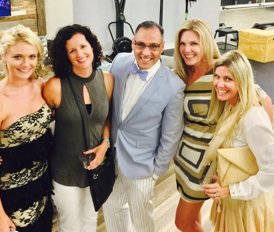 Luis surrounded by friends and clients. 