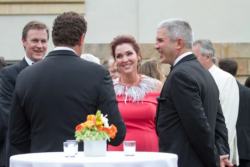 Event chairs Jay Everette (back to camera) and Brian Speas, right) talk with guests Mark and Samantha McCall. 