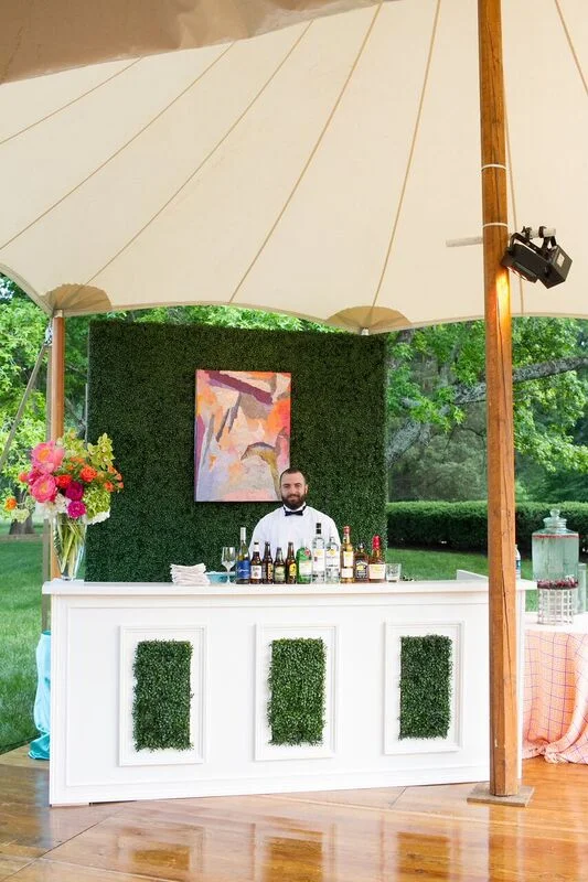 The tent's sides were open to show off the Mint Museum Randolph's vast park-like setting. Bar and cocktail tables were wrapped in boxwood and featured original art work by Herb Jackson, whose works are in the Mint’s permanent collection.
