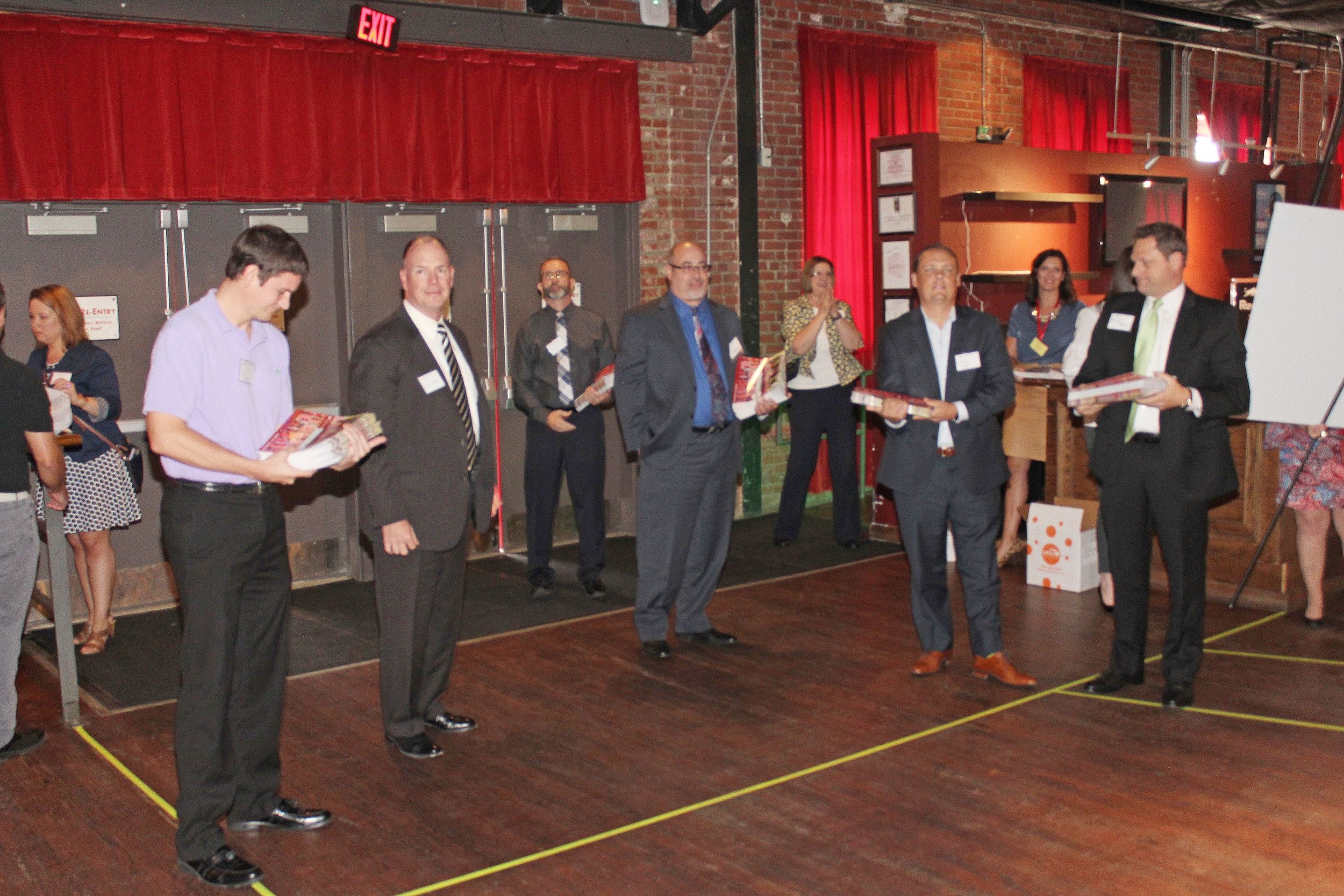 Stiletto Swagger participants hand out calendars to guests.