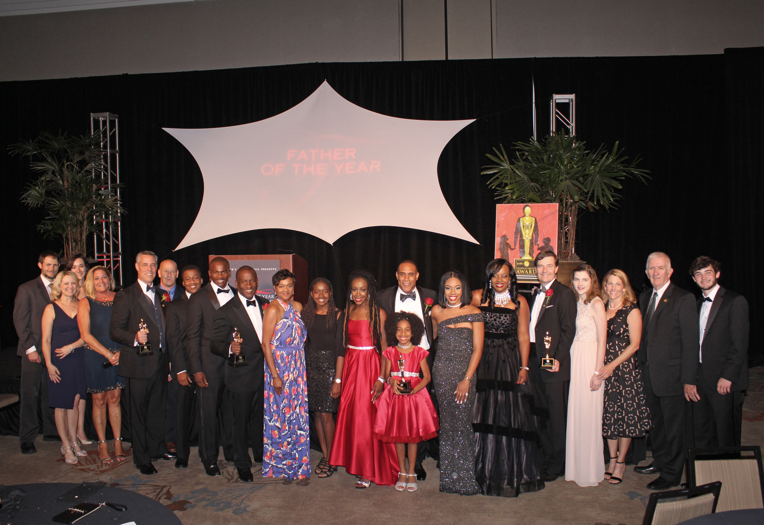  The 2019 Fathers of the Year surrounded by their families. 