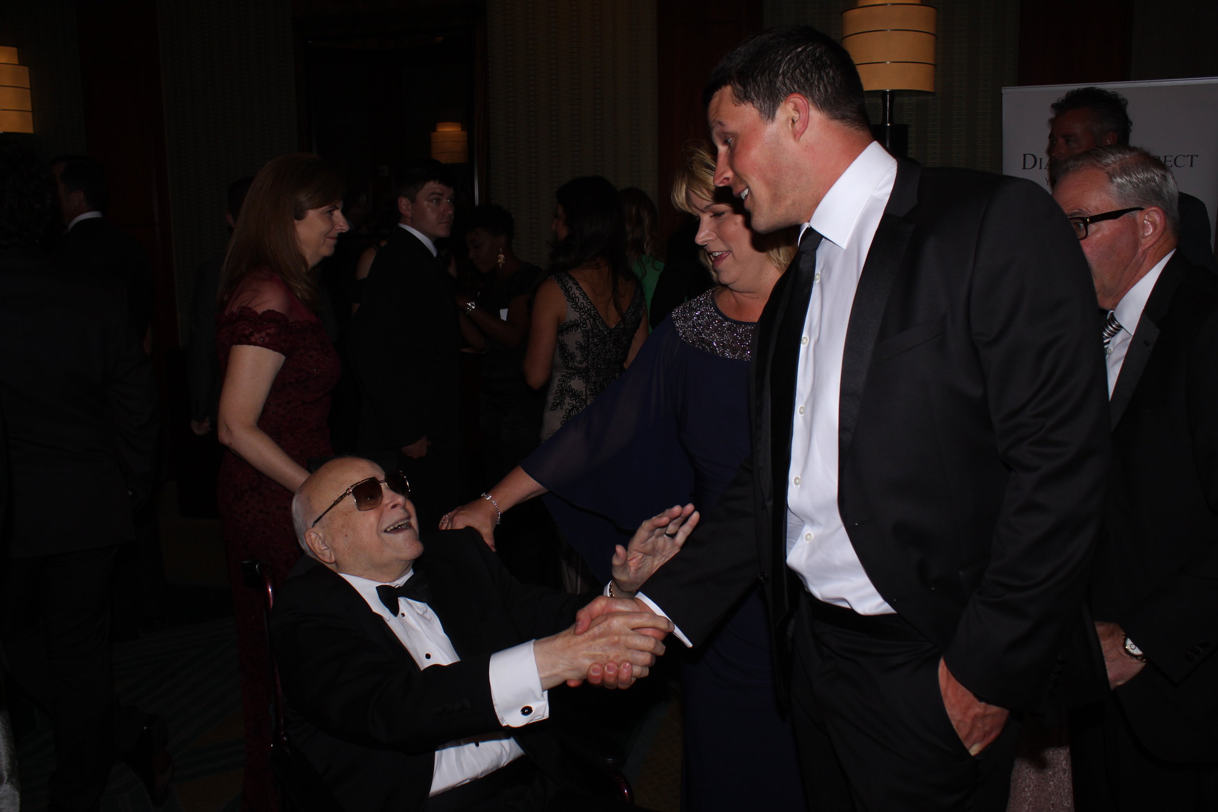  Speedway Children’s Charities Founder Bruton Smith greets Carolina Panthers player Luke Kuechly. 