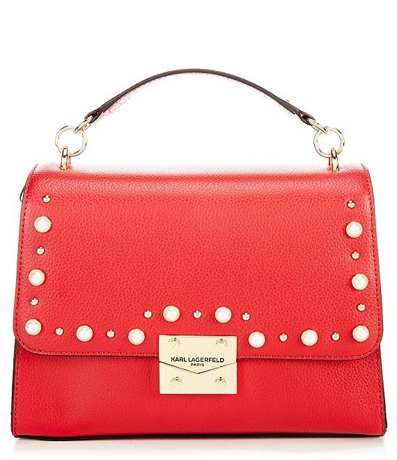   KARL LAGERFELD PARIS CORINNE PEARL TOP HANDLE SHOULDER BAG: Leather with faux pearl and studded detail. Available in red or black. $198. Dillard’s.  