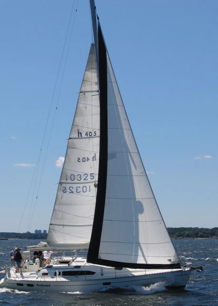 Above a Hunter 40.5 with a navy blue UV leech and foot covers sewn to the sail. Below : The same sail roller furled showing the UV covers protecting the sail. 