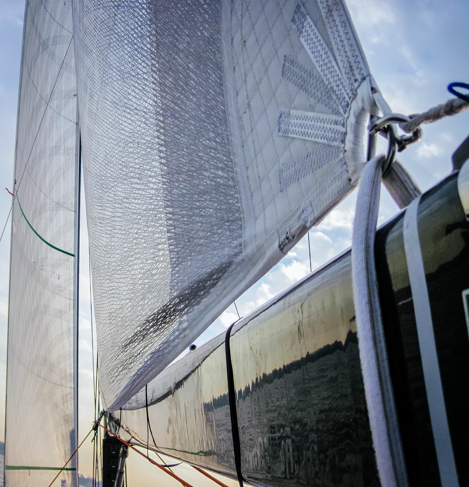 A Titanium loose-footed mainsail. A velcro strap around the boom takes the place of a clew slug or clew car.