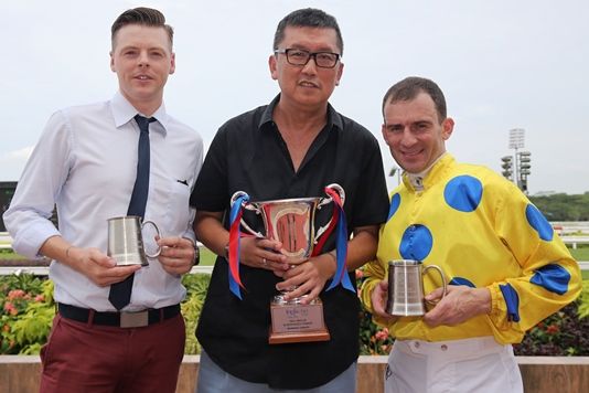 Trainer James Peters, owner Phua Chian Kin and jockey Vlad Duric pose with their trophies.