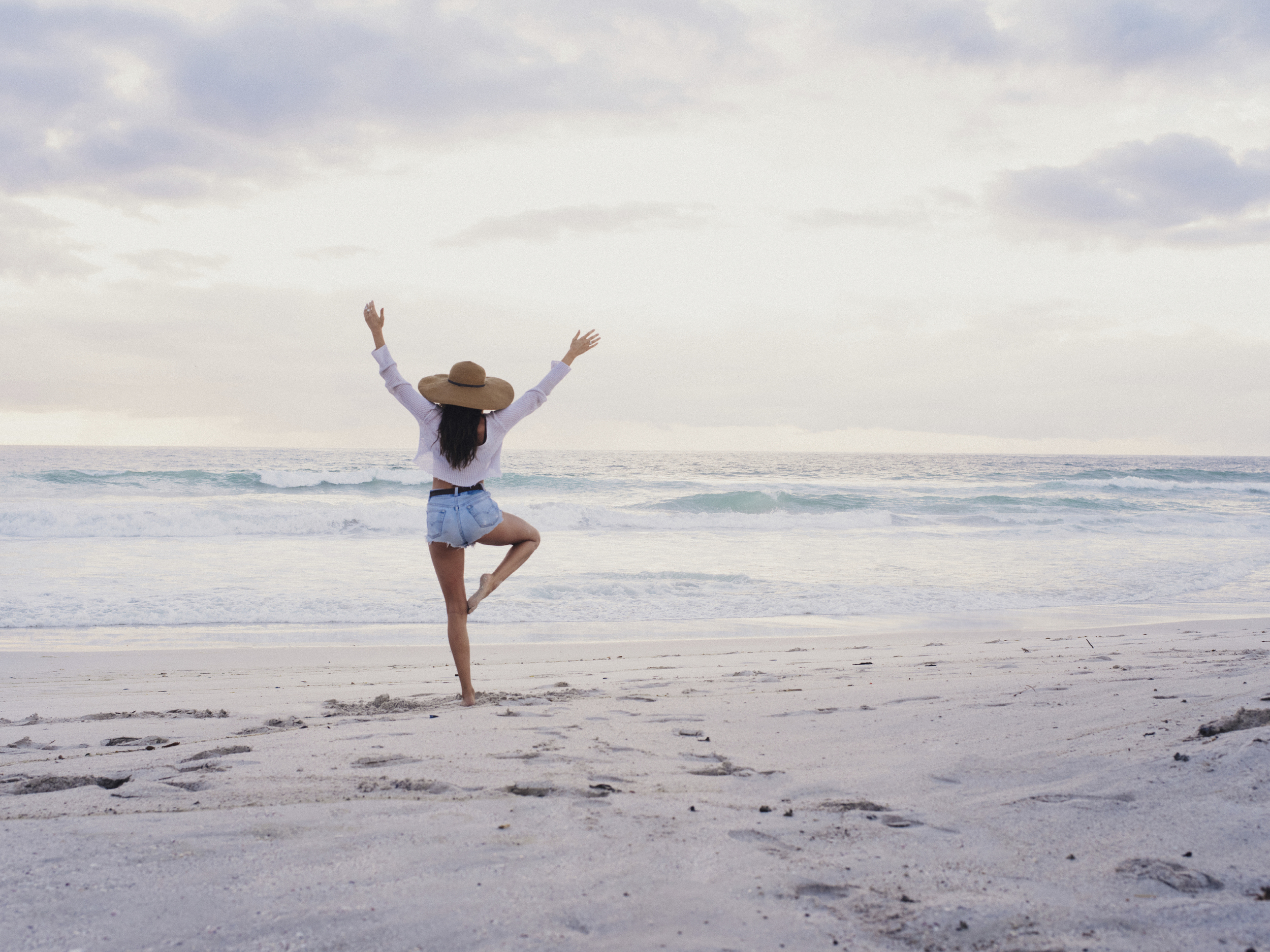 Hipster-Girl-Practicing-Yoga-Pose-on-Beach-000087632019_Large.jpg