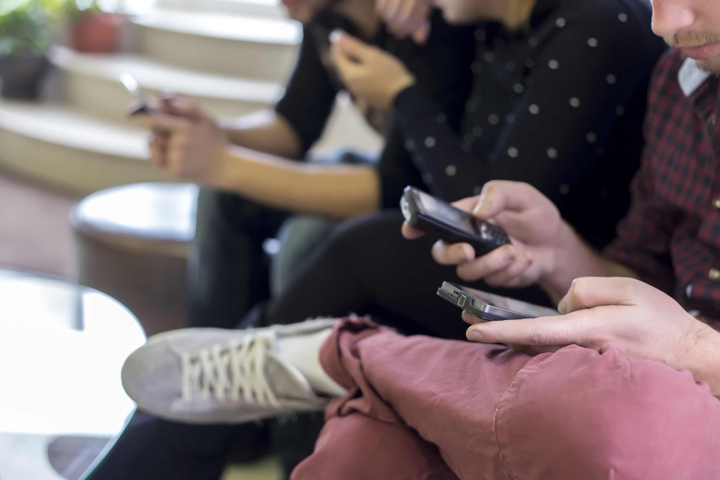 049821702-people-holding-their-smartphon.jpeg