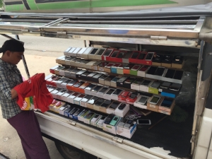 Yangon mobile phone market stall vendor and his wares. Source: Ronda Zelezny-Green