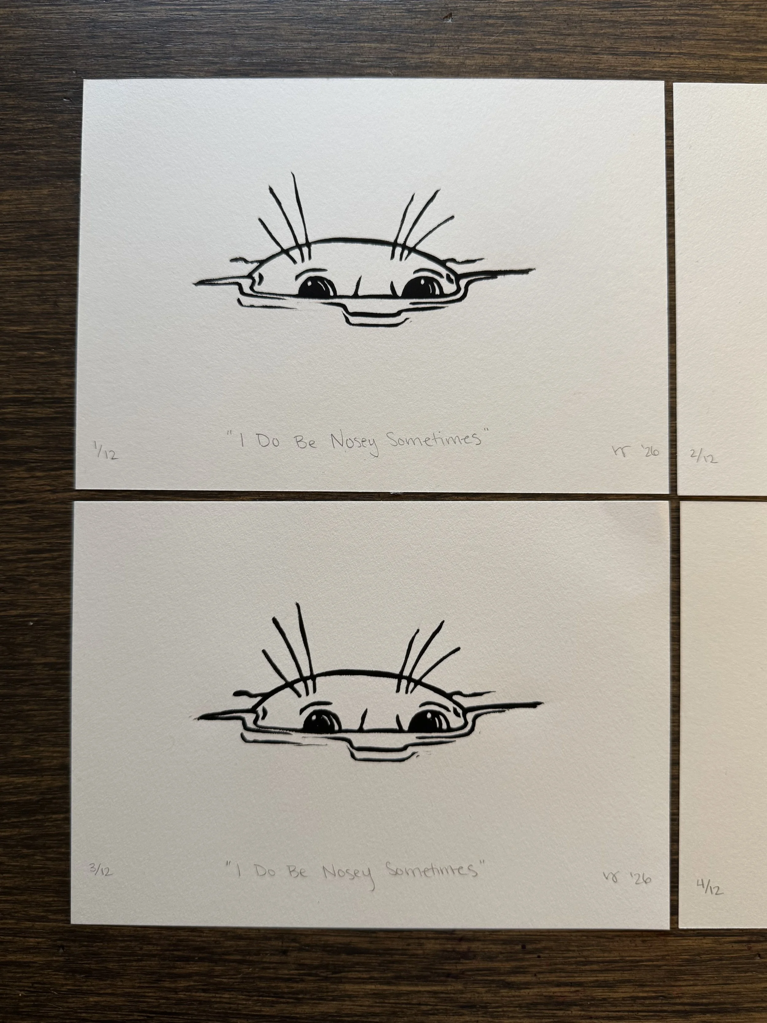 2 Black and white linoprints of a nosey seal poking its head out of the water