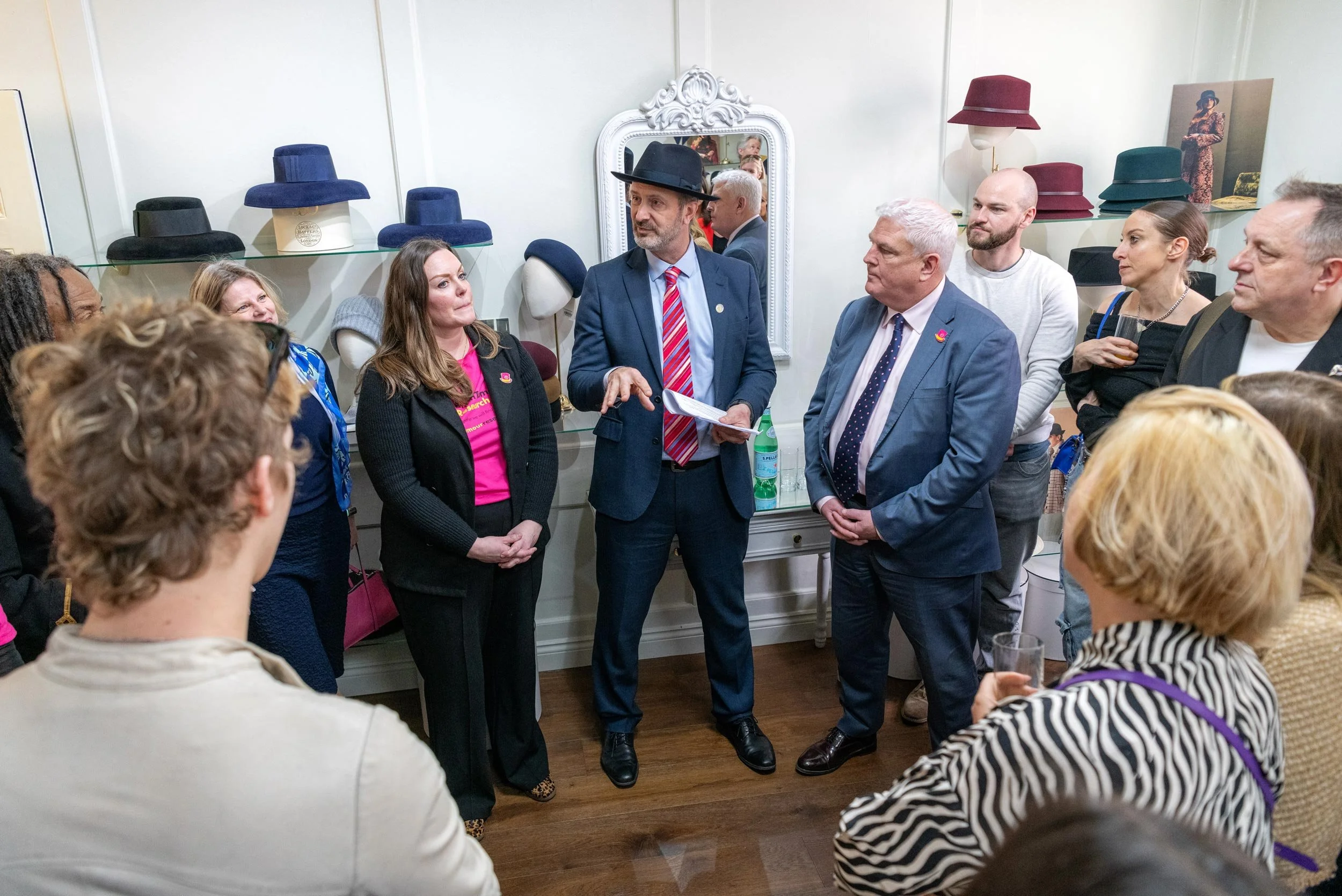 Speaker addressing guests during the Brain Tumour Research Wear A Hat Day event in London.