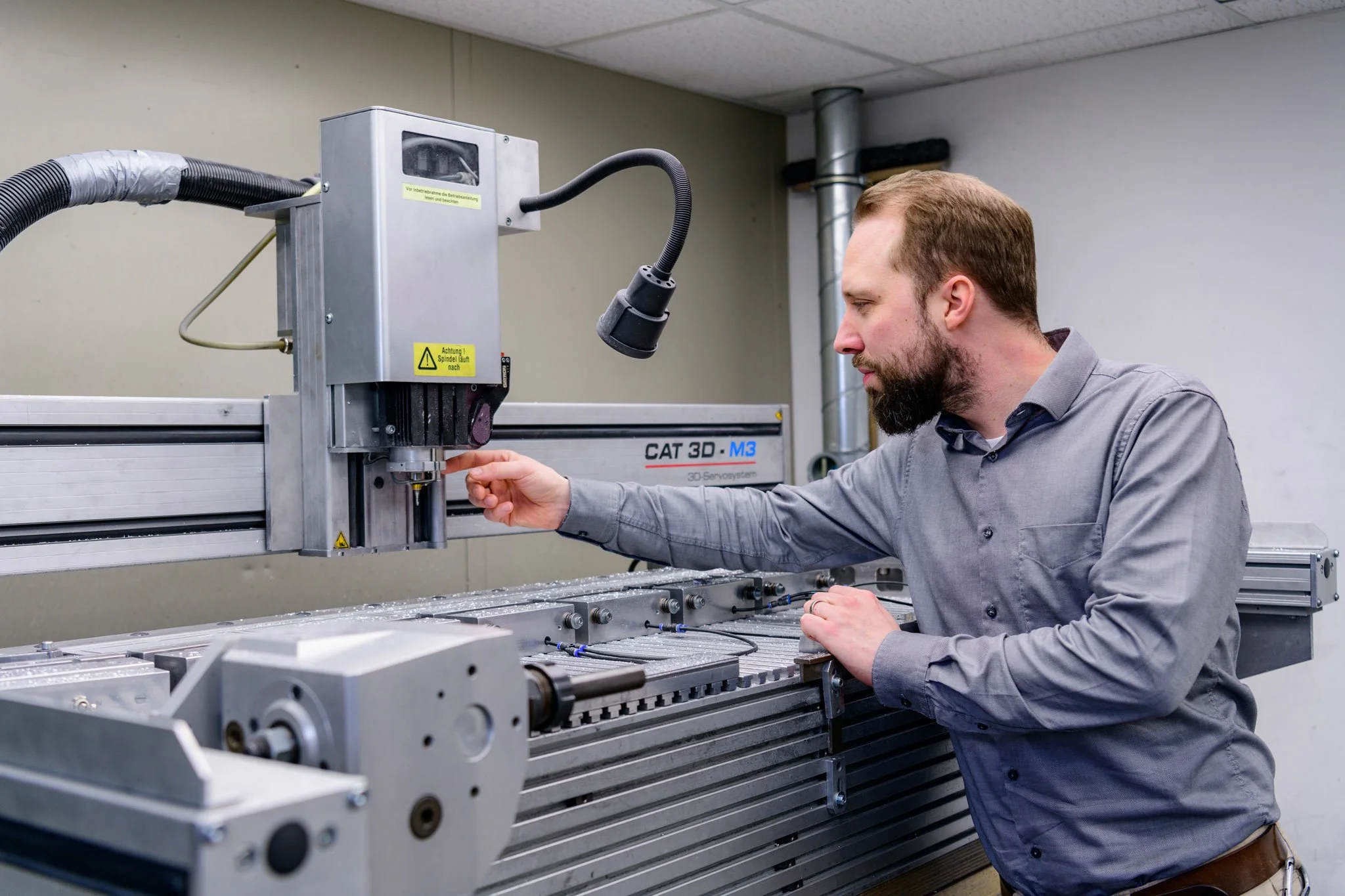 Engineer calibrating a CNC machine in a precision engineering facility – industrial photographer London