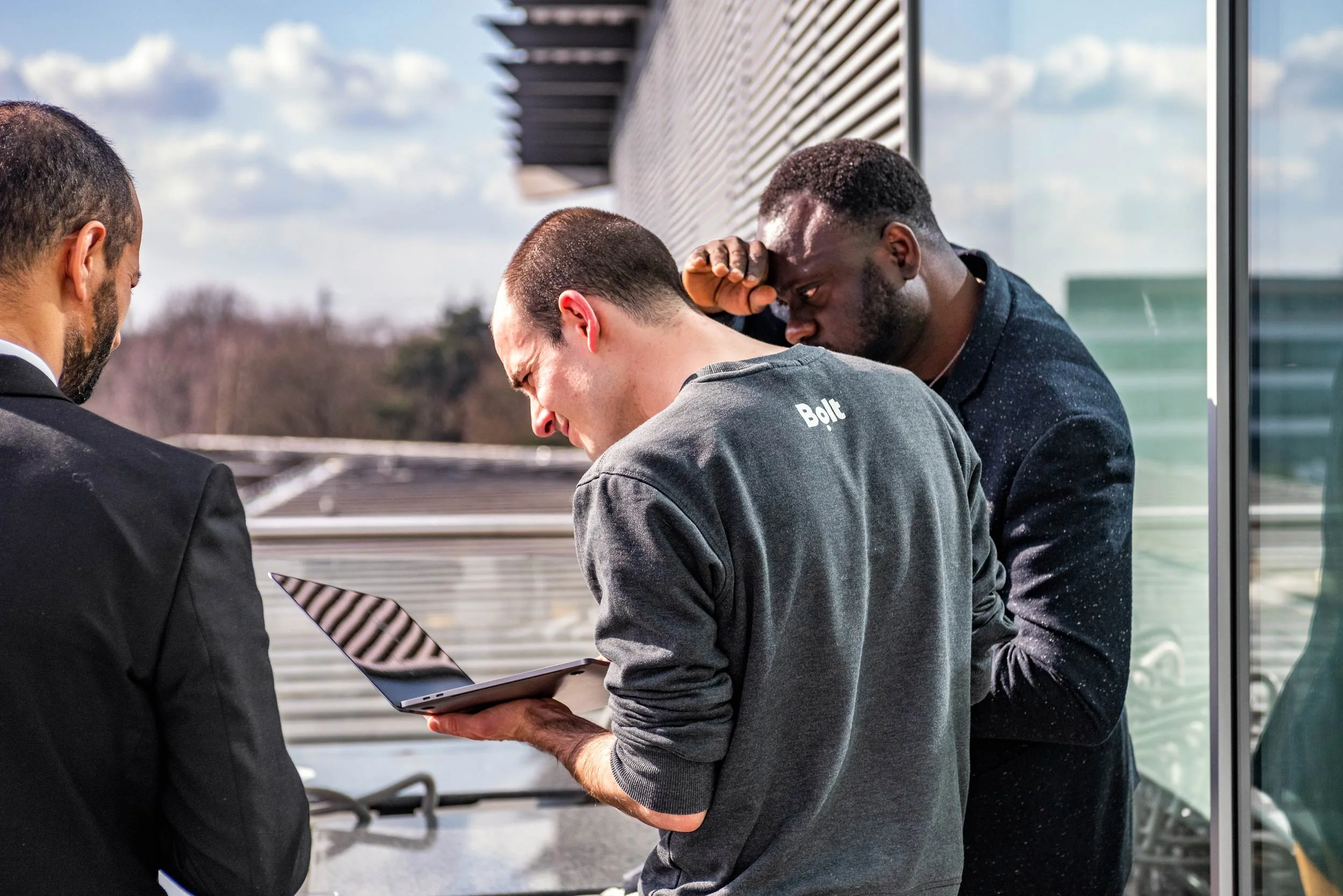 Bolt team reviewing the run of show on a laptop at Mercedes-Benz World