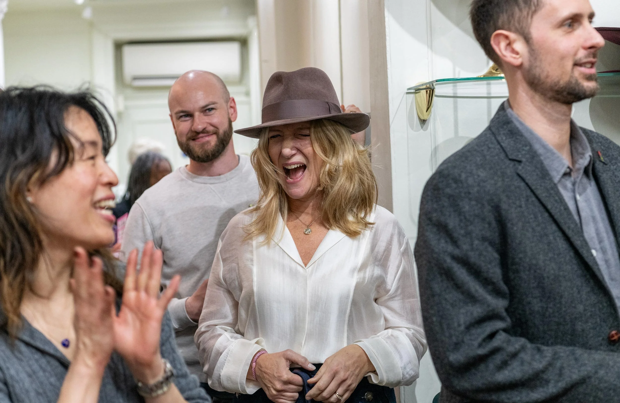 Candid guest photography during the Brain Tumour Research Wear A Hat Day event in London.