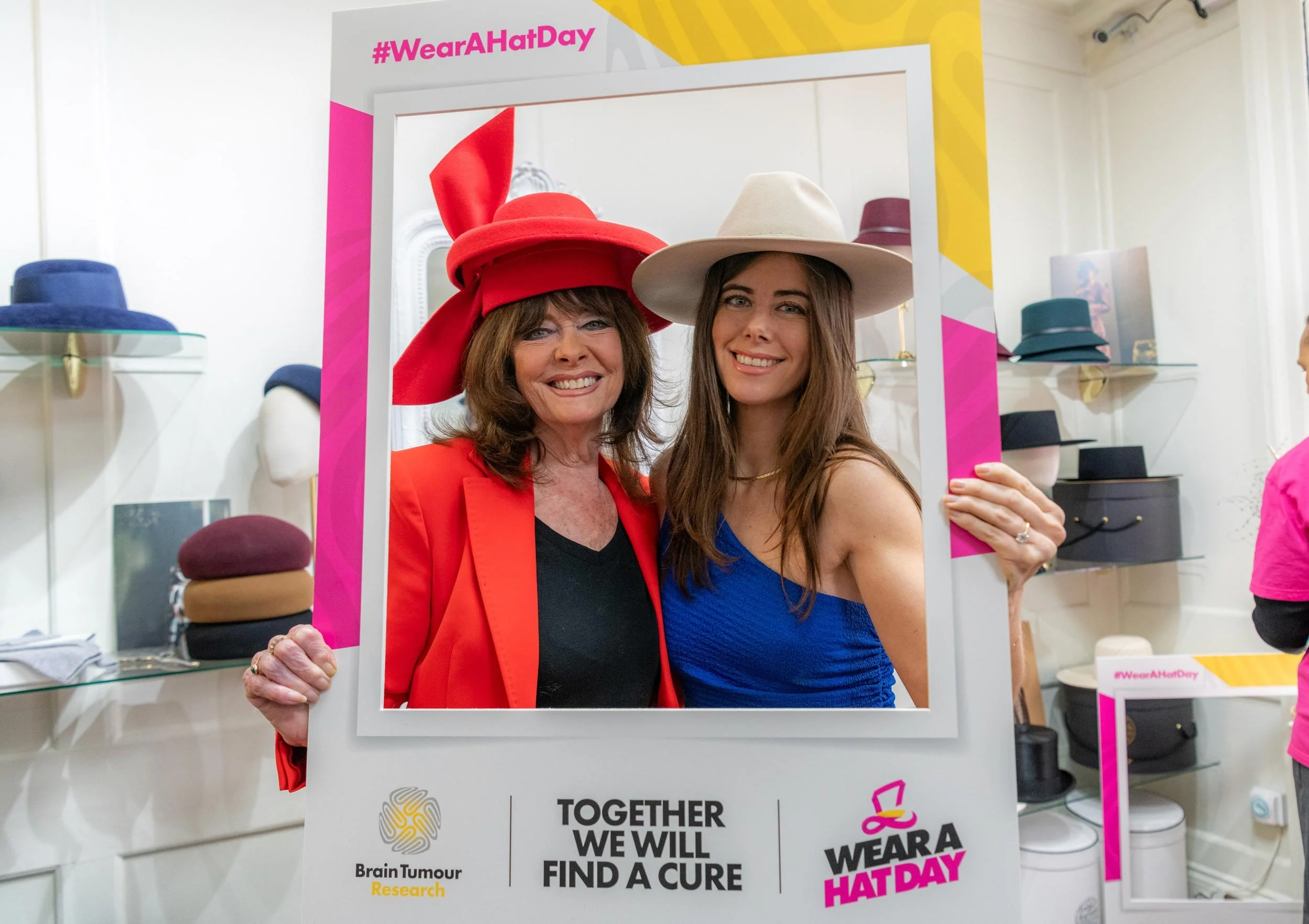 Guests with Brain Tumour Research Wear A Hat Day campaign branding at the London event.