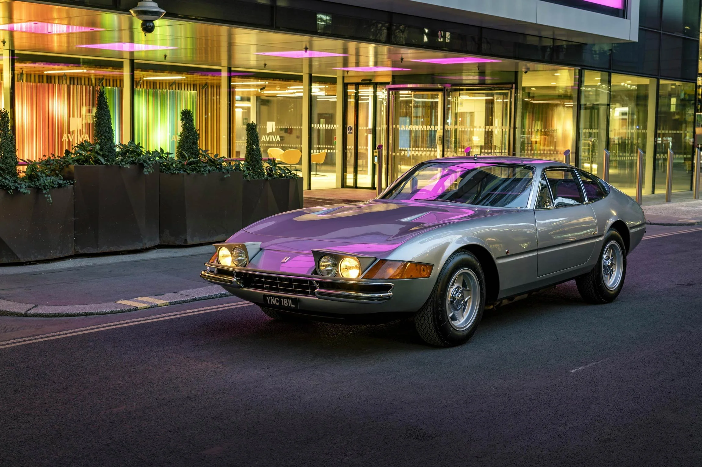 Silver Ferrari Daytona front three-quarter view at night in London with purple lighting – classic car photographer London
