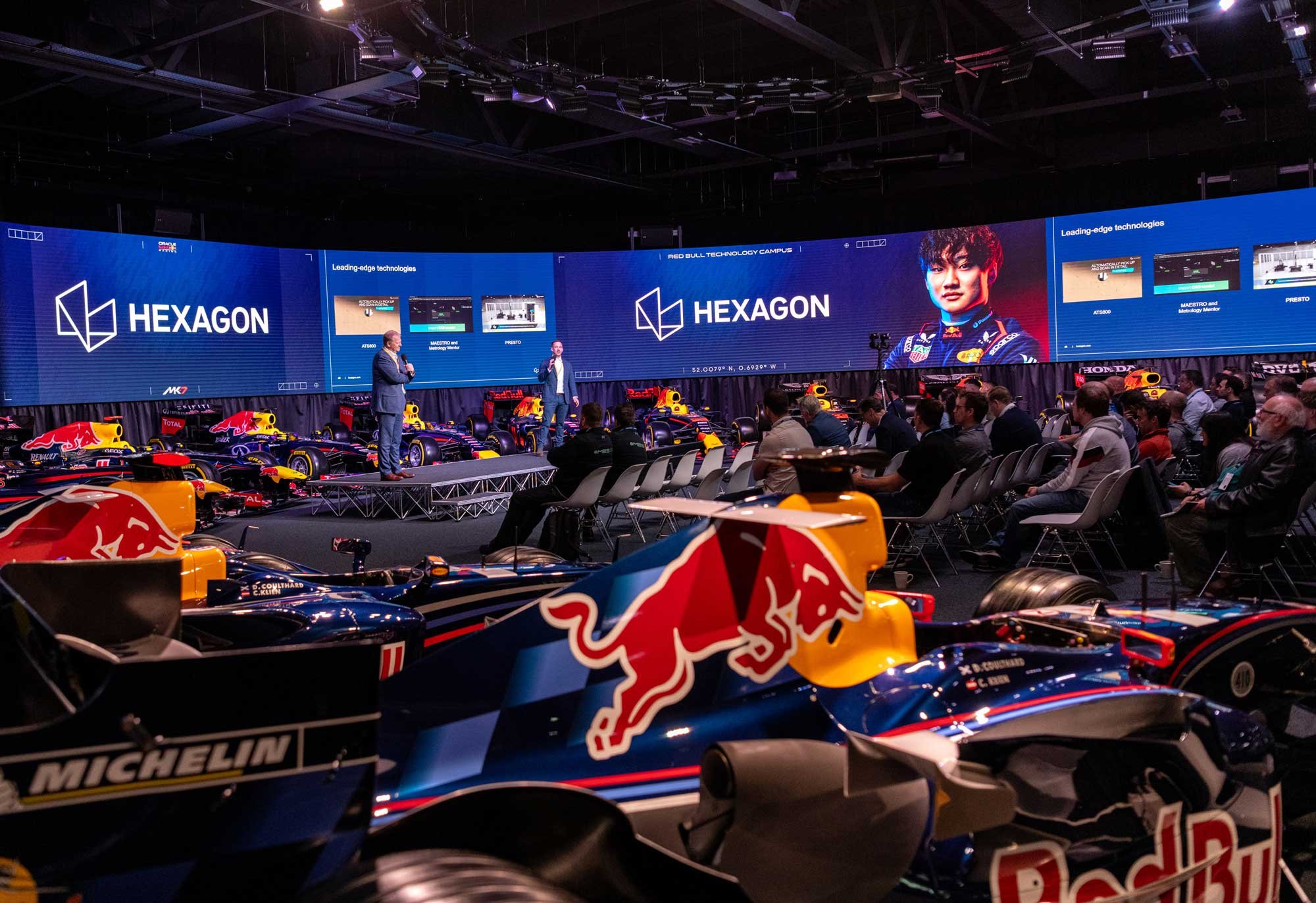 Conference photographer London capturing a Hexagon and Red Bull Racing technology event with stage presentation and Formula 1 cars