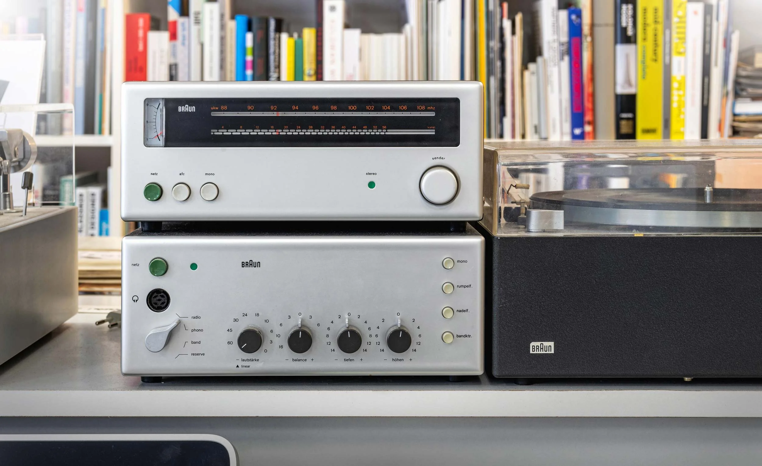 Vintage Braun hi-fi equipment, including a silver radio receiver and turntable, displayed together in the Braun design collection.
