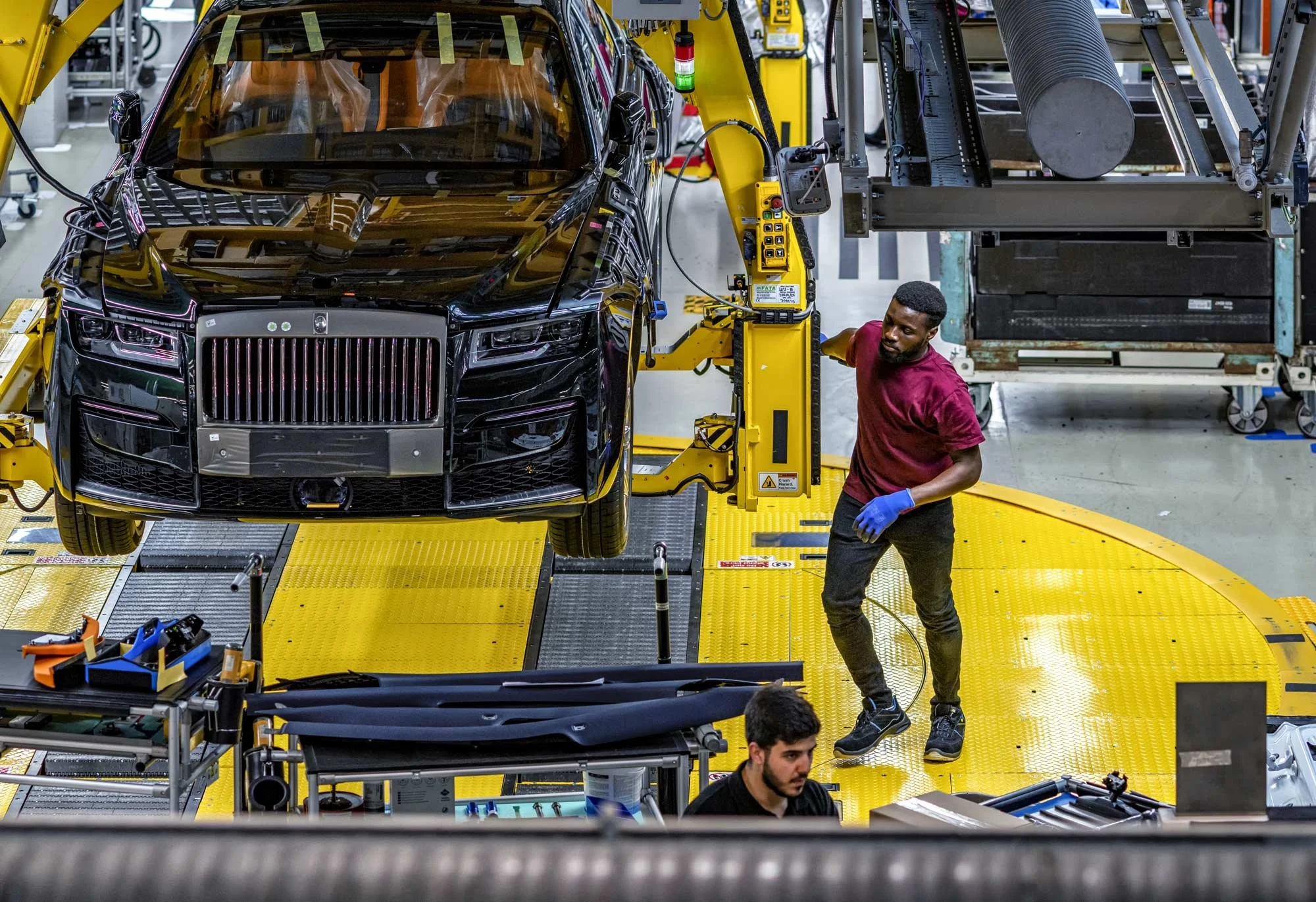 production-line-engineer-working-on-lifted-luxury-car-industrial-assembly-photography-london.jpg