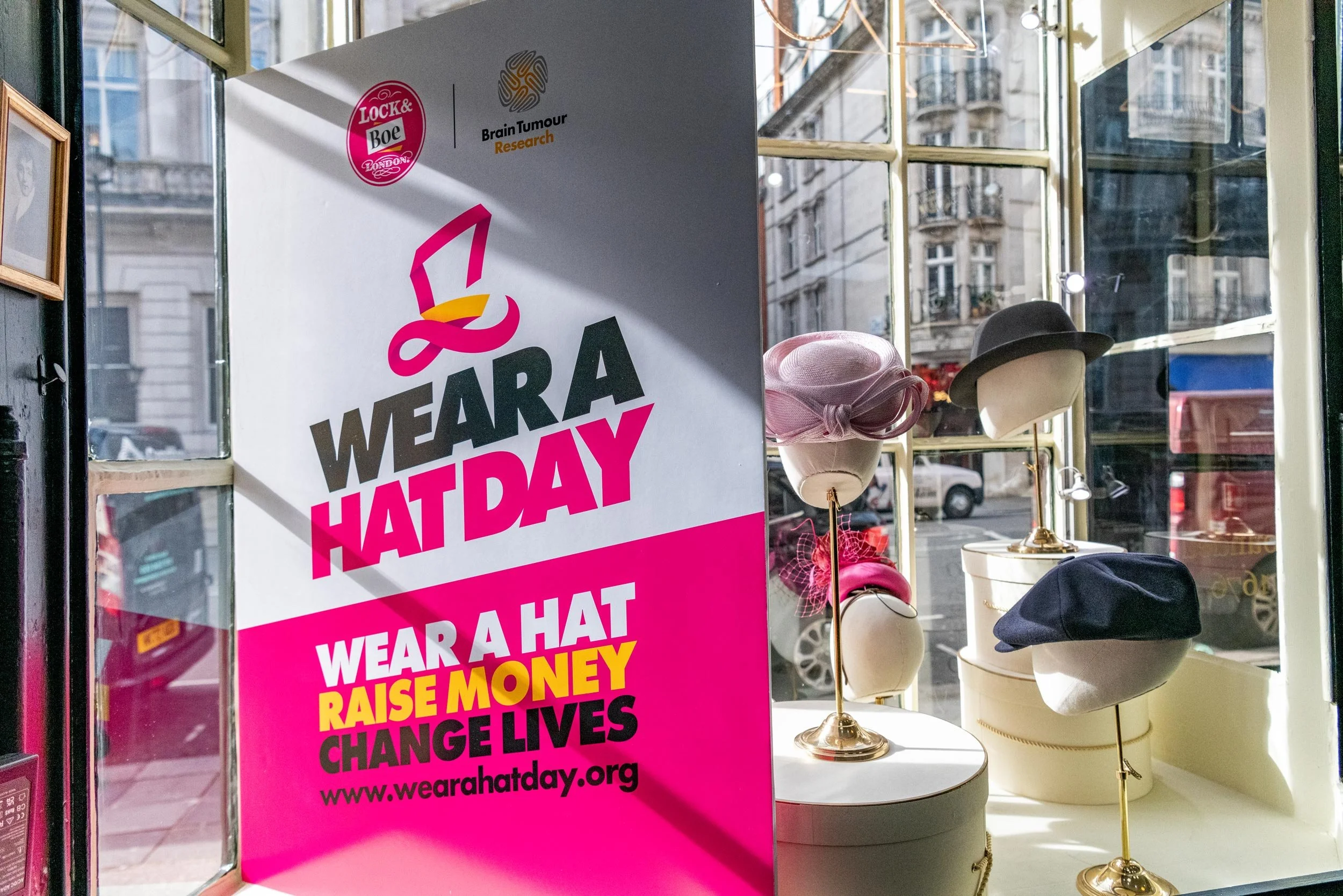 Brain Tumour Research Wear A Hat Day campaign branding at Lock & Co. Hatters in London.