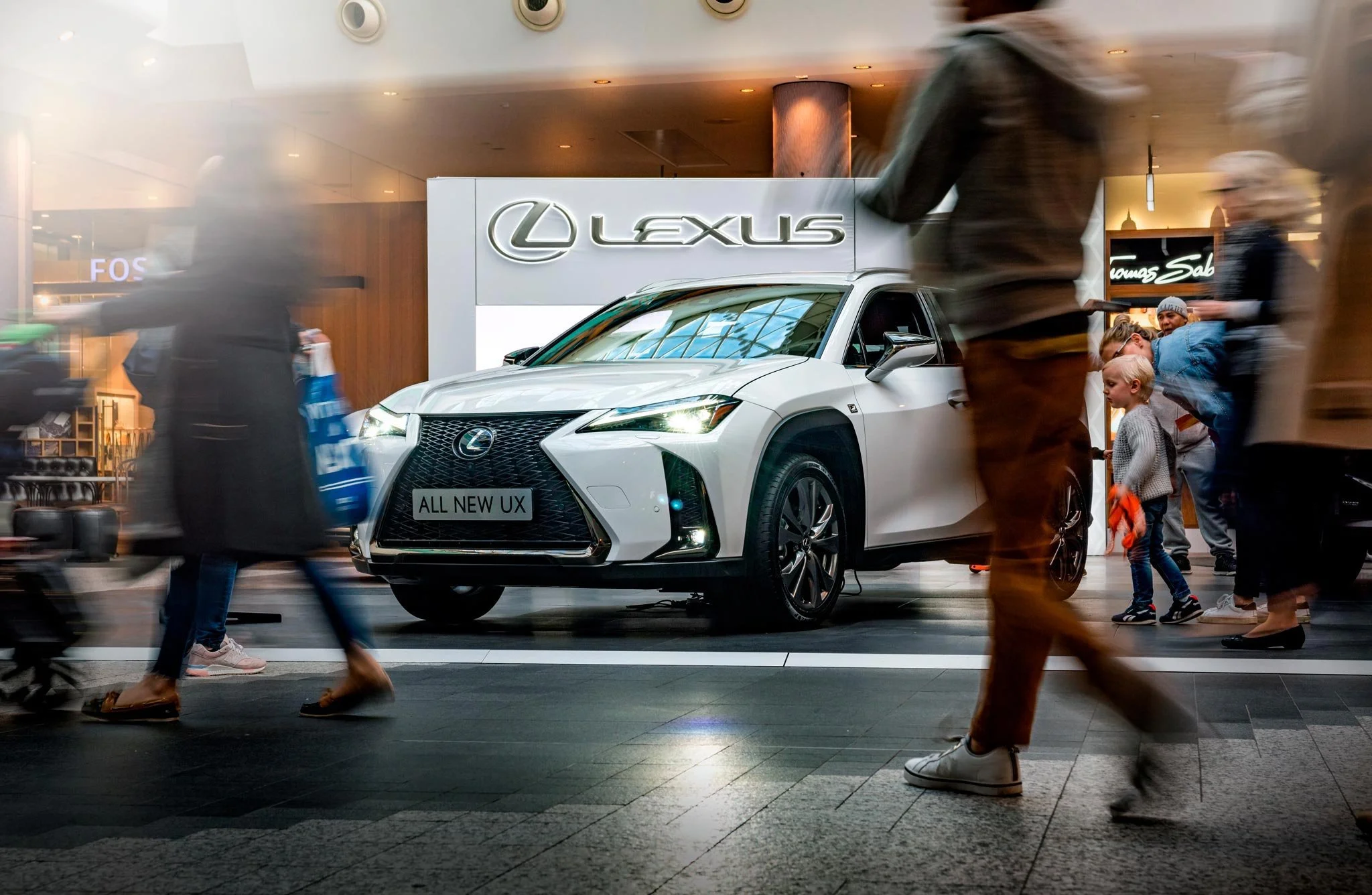 White Lexus UX on display during brand activation in a busy London shopping centre – automotive events photography