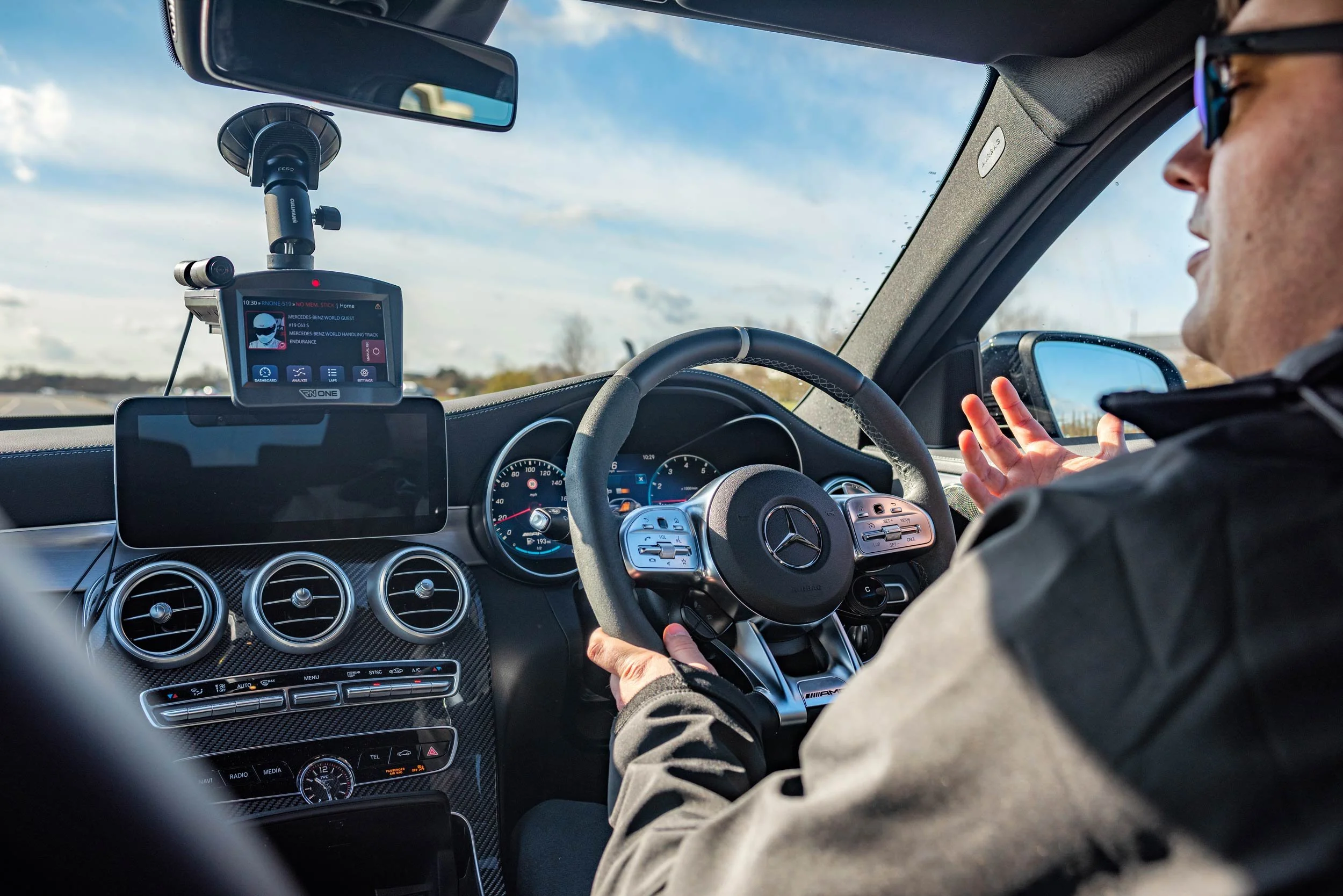 AMG instructor in the cockpit during a driving session at Mercedes-Benz World — corporate event photographer London