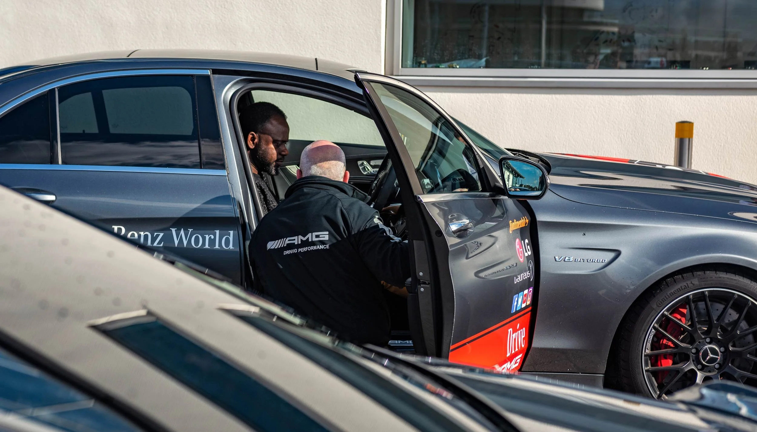 AMG instructor talking a driver through the car at Mercedes-Benz World — automotive event photographer London