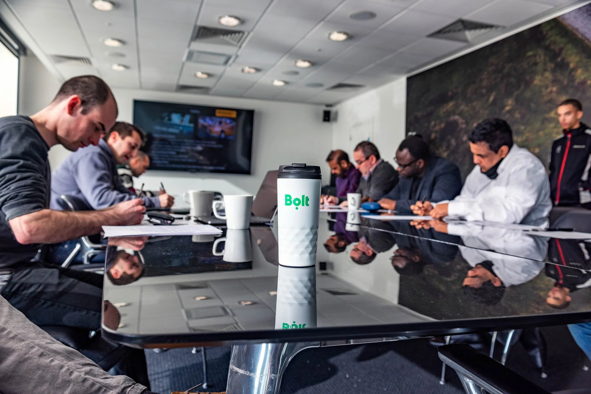 Bolt branded travel cup on the briefing table during a corporate driver event at Mercedes-Benz World