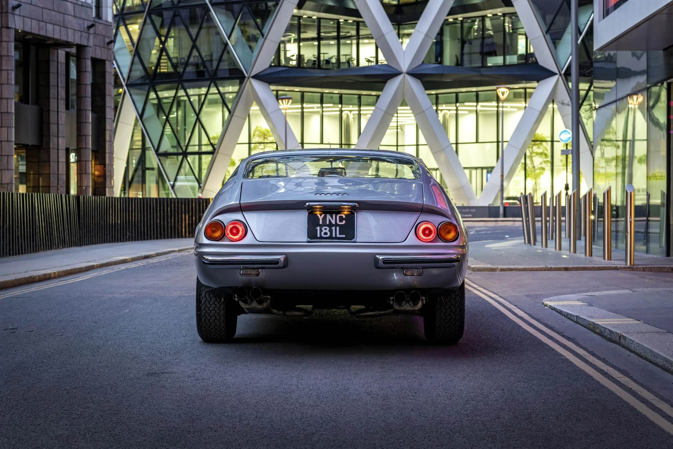 Ferrari Daytona classic rear view photographed at night near The Gherkin in the City of London by classic car photographer Dean Wright