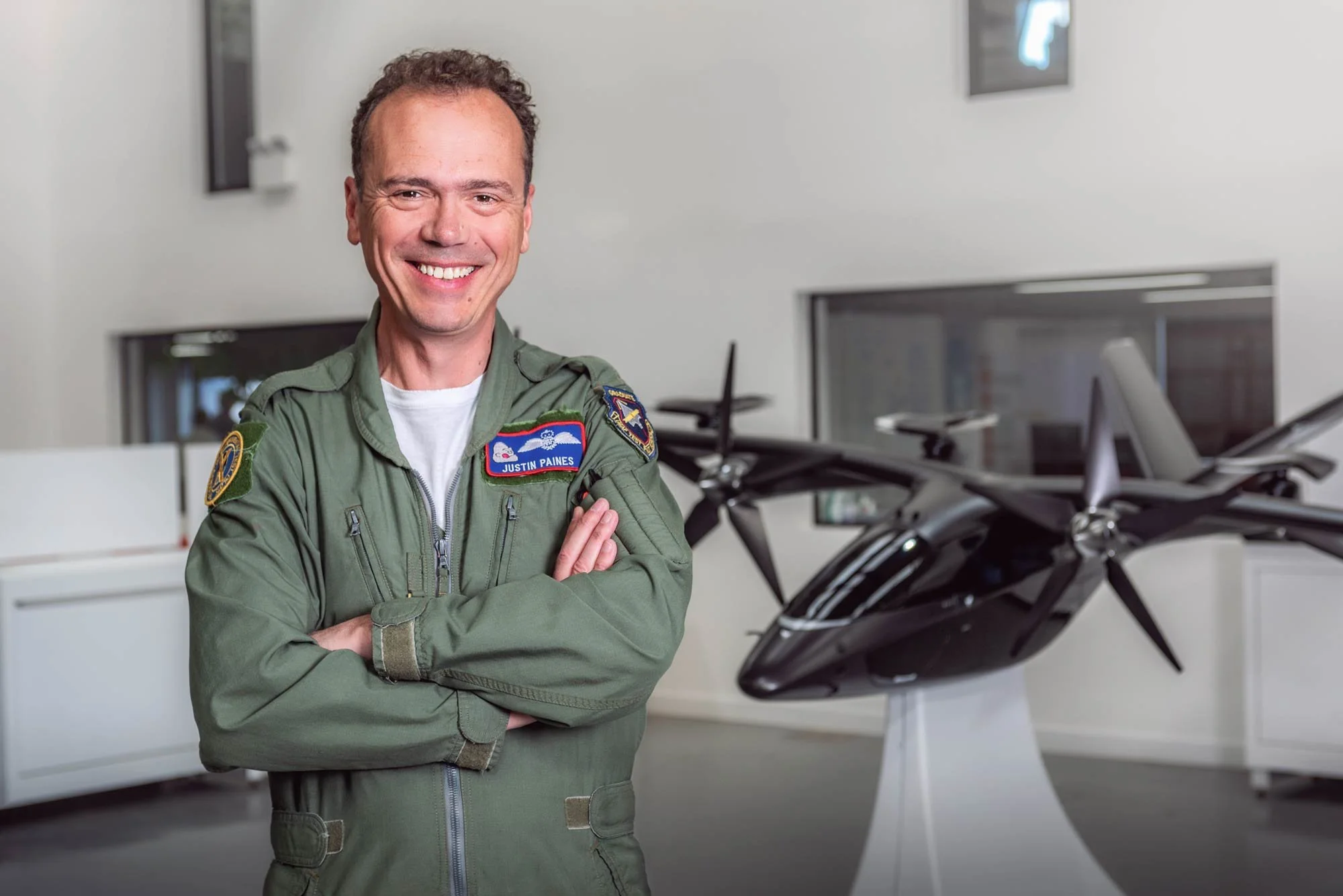 Professional pilot portrait inside an aerospace hangar – aerospace photography London