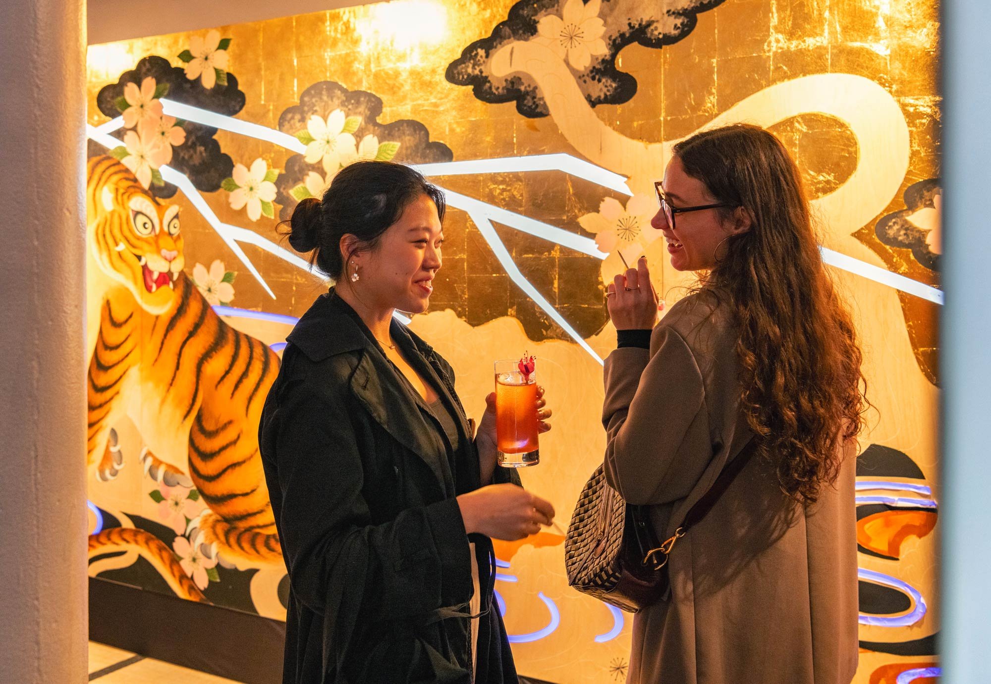Guests in front of tiger mural brand activation photography London