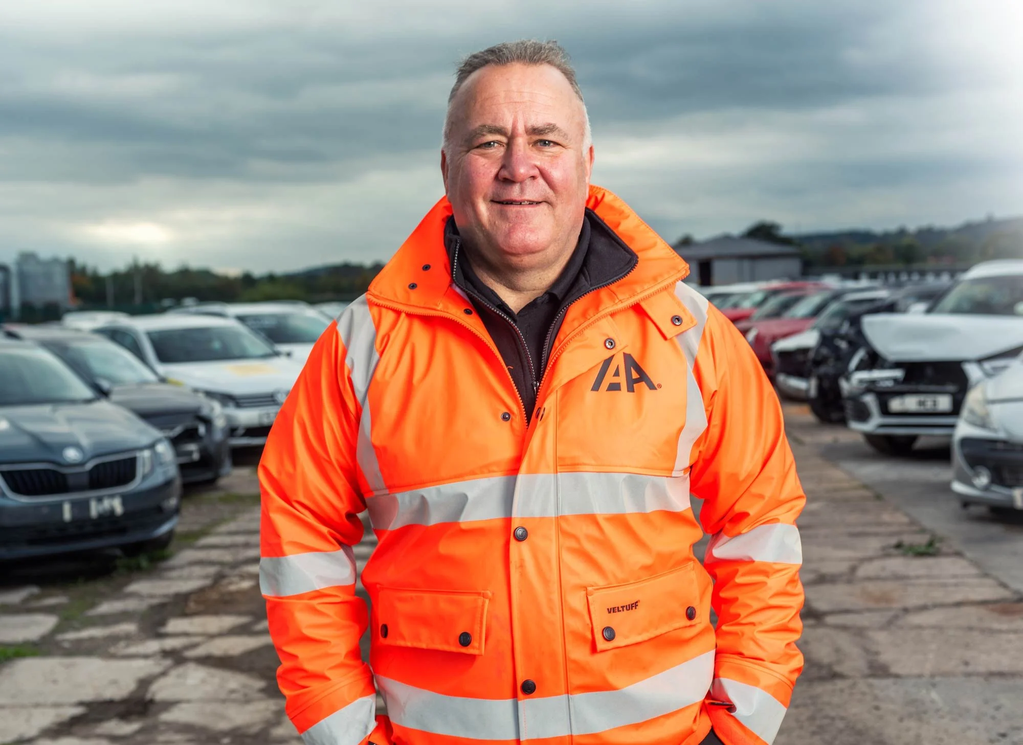 Industrial portrait photography – senior engineer in high-visibility workwear at automotive facility, Dean Wright commercial photographer