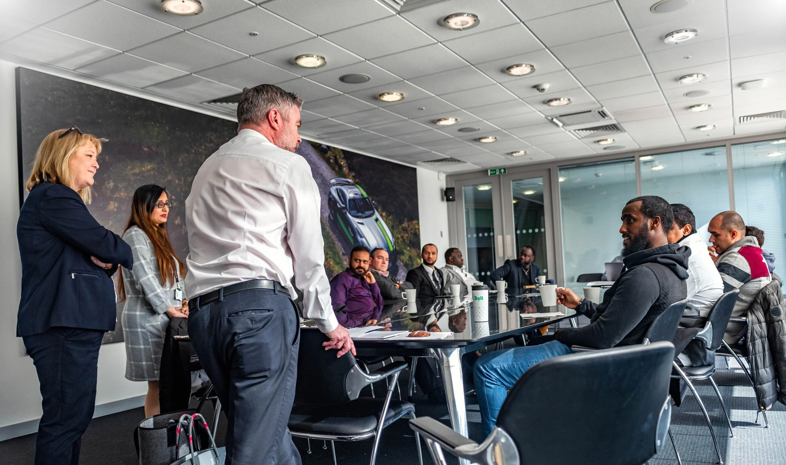 Morning briefing for Bolt drivers in a Mercedes-Benz World meeting room — driver event photographer London