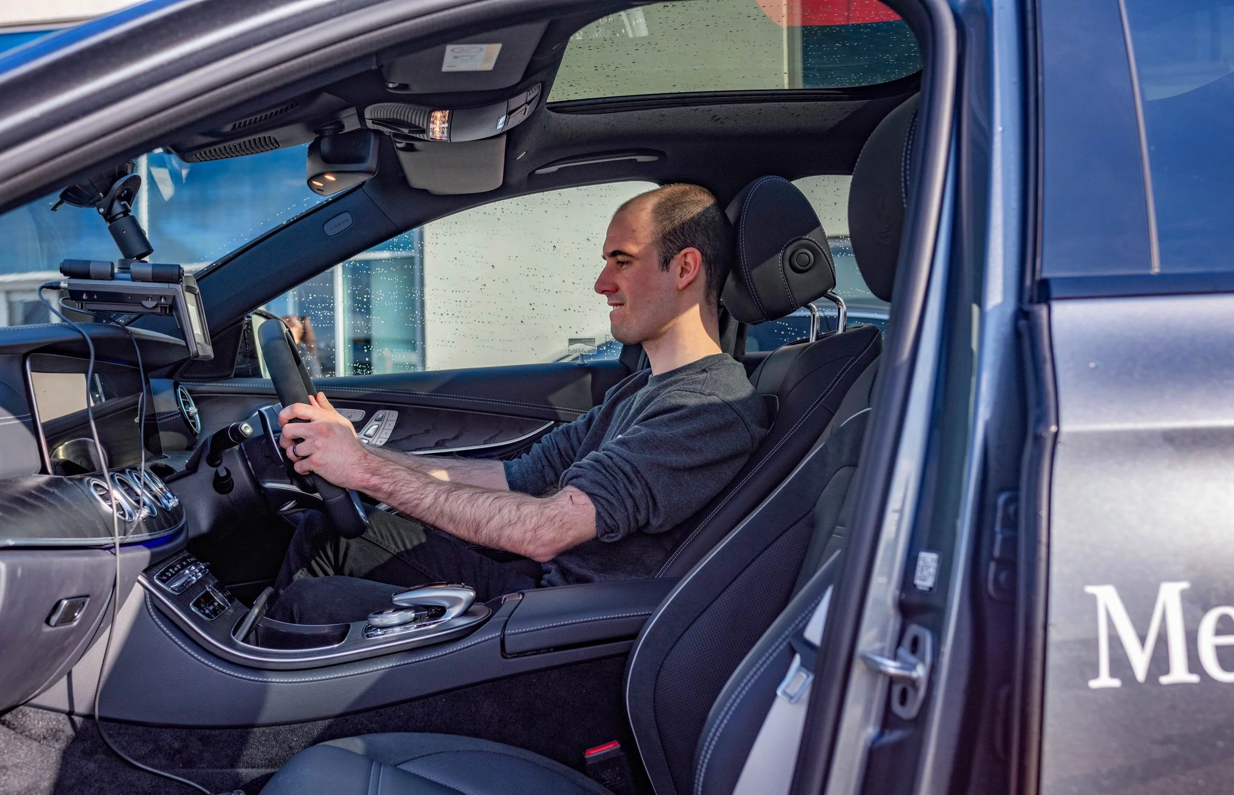 Bolt marketing team in the seat of a Mercedes-AMG at Mercedes-Benz World