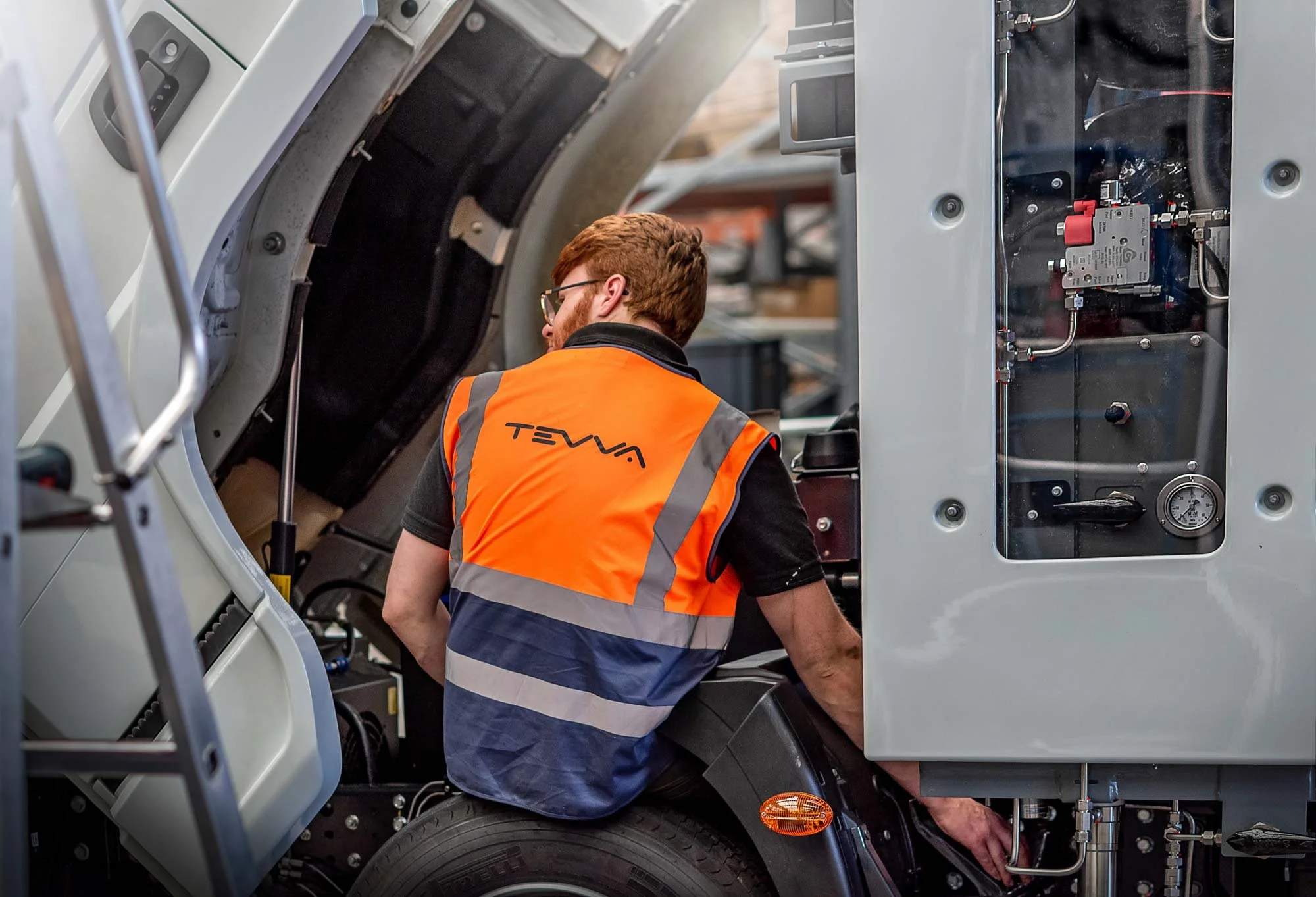 Engineer working on electric truck during assembly in a modern manufacturing facility – industrial photographer London