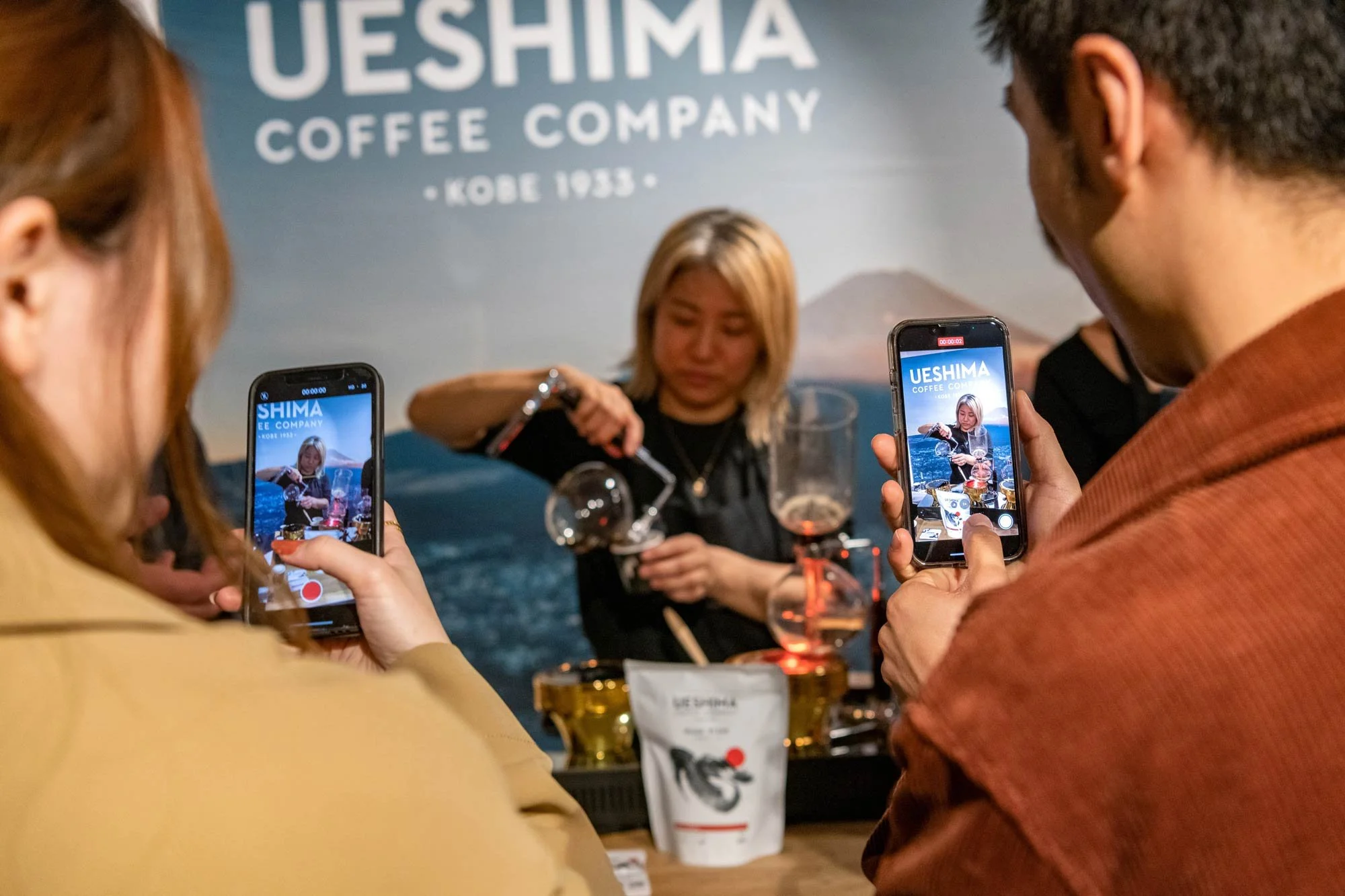 Guests filming Ueshima Coffee demonstration brand activation photography London