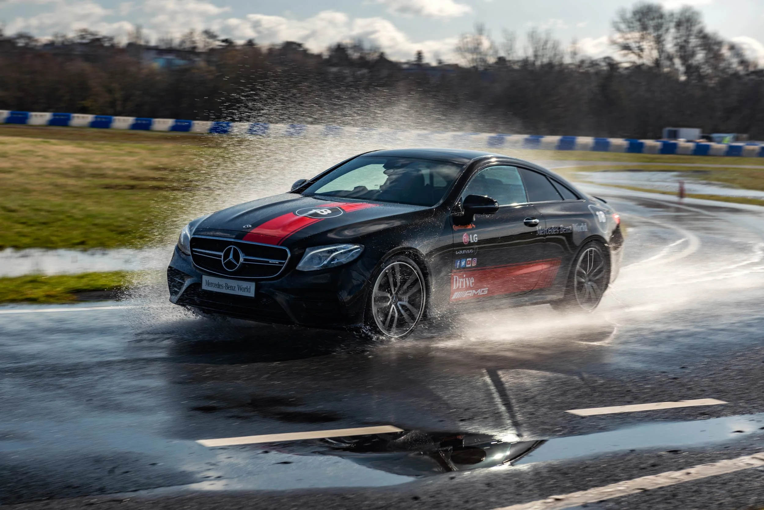 Mercedes-AMG E53 coupe on the wet Mercedes-Benz World circuit during a Bolt driver event