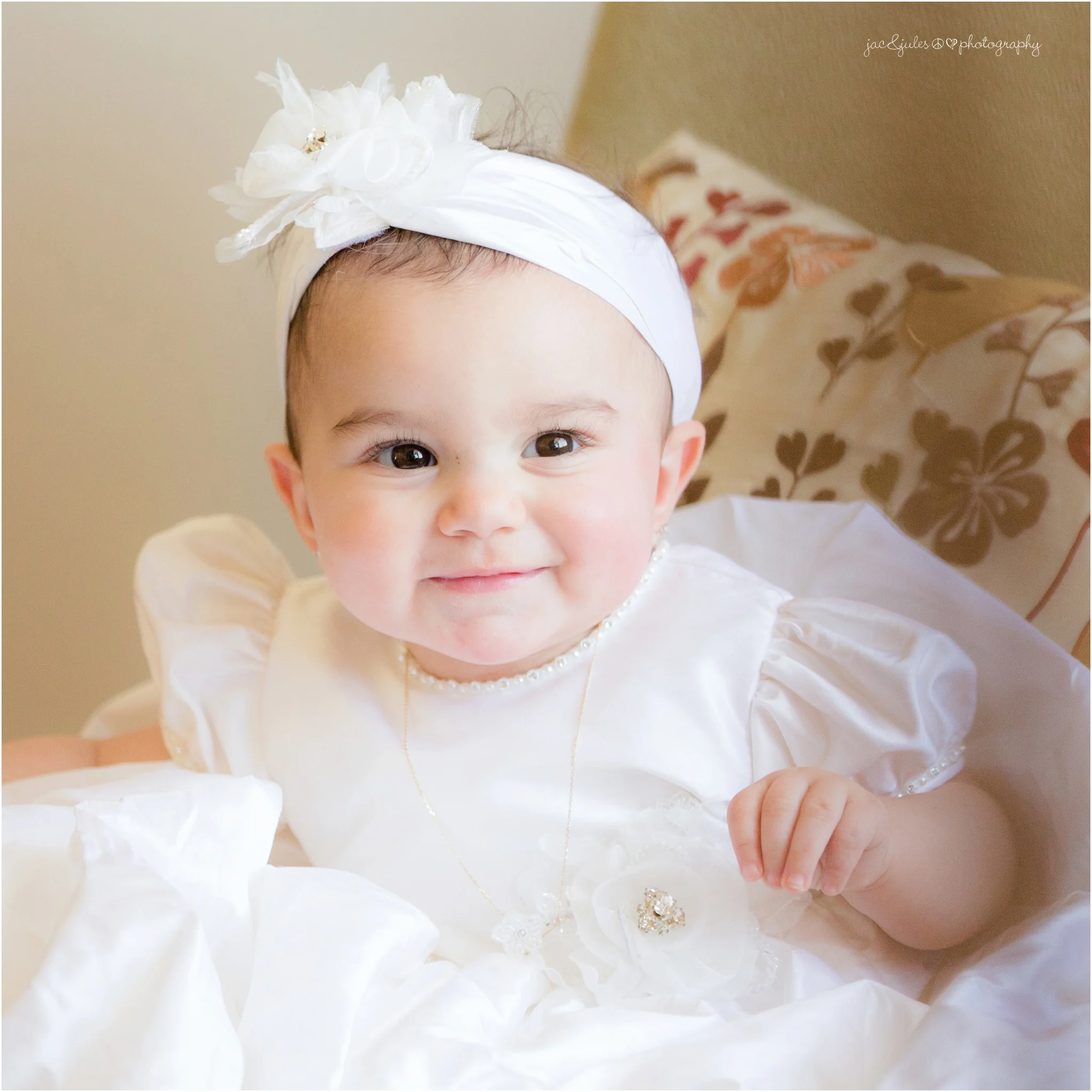 angelic close up of baby girl in christening gown