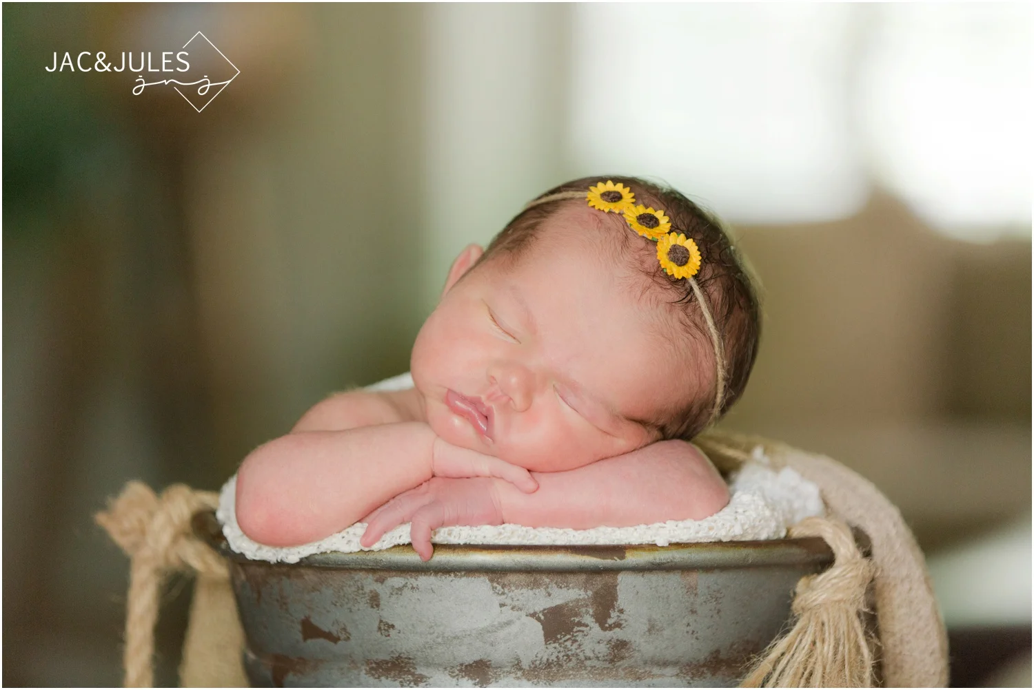 newborn baby girl in sunflower headband at home in middletown, nj