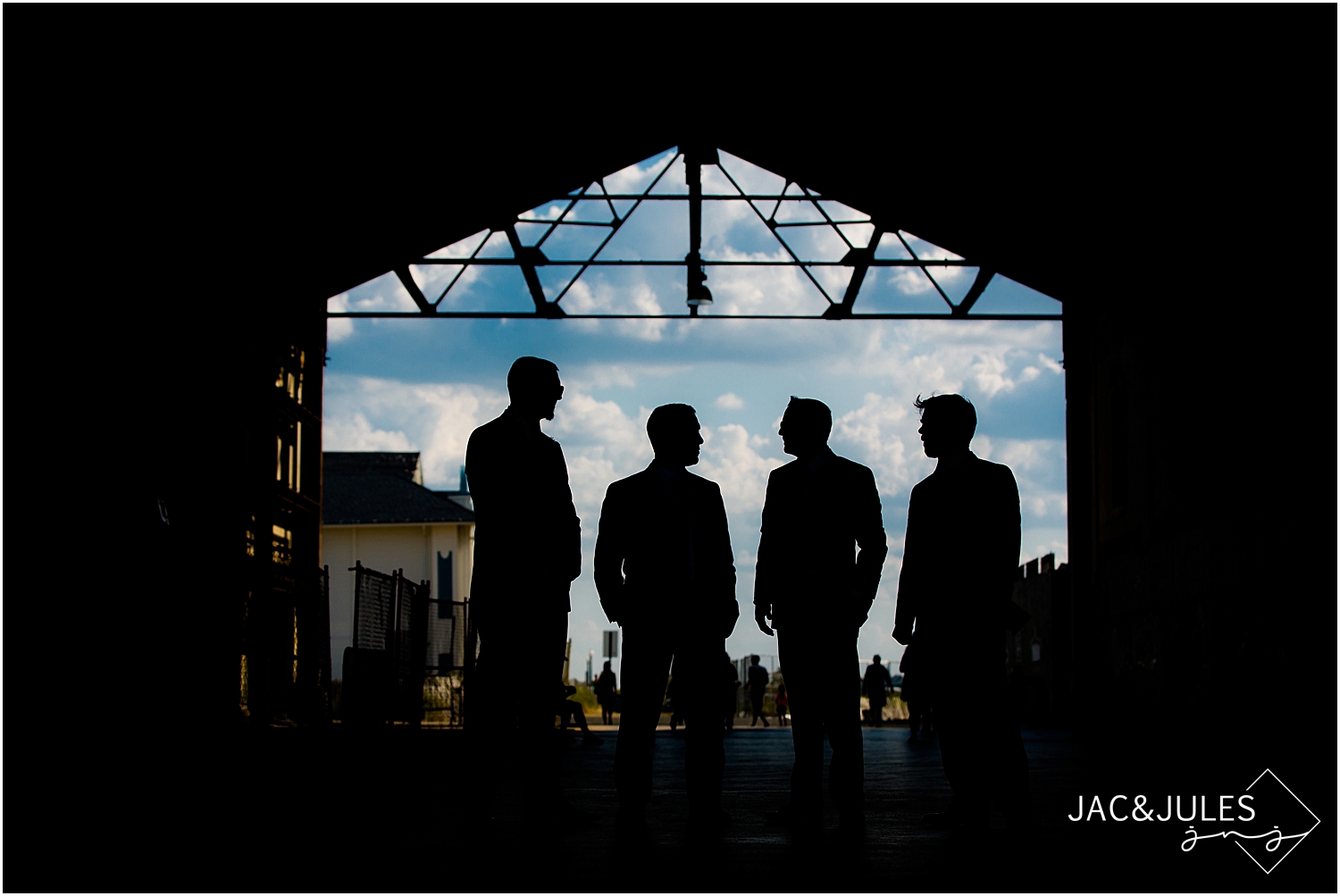 jacnjules photographs groomsmen in gray suits in Asbury Park, NJ